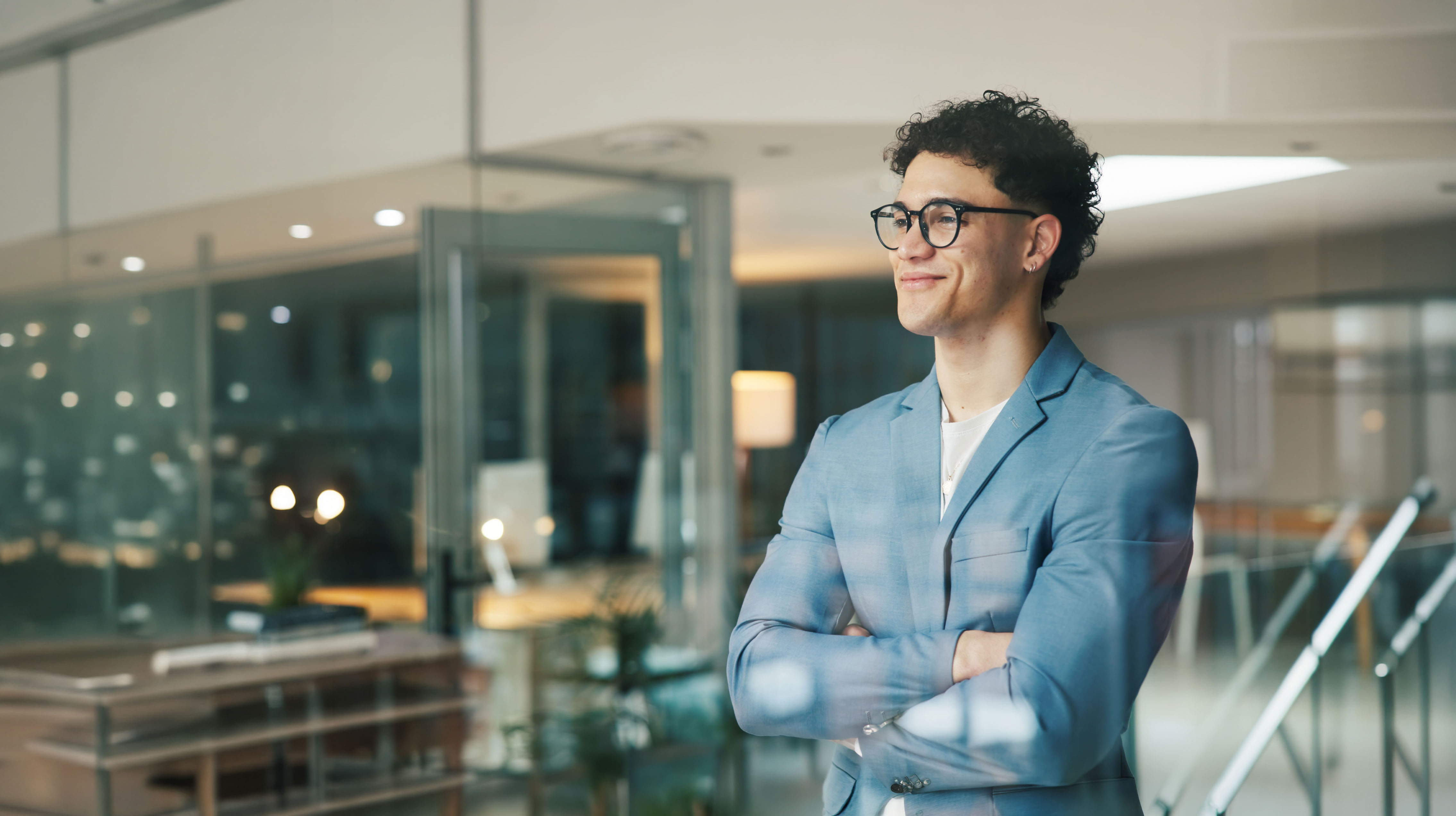 A young man looking toward the horizon in an office.