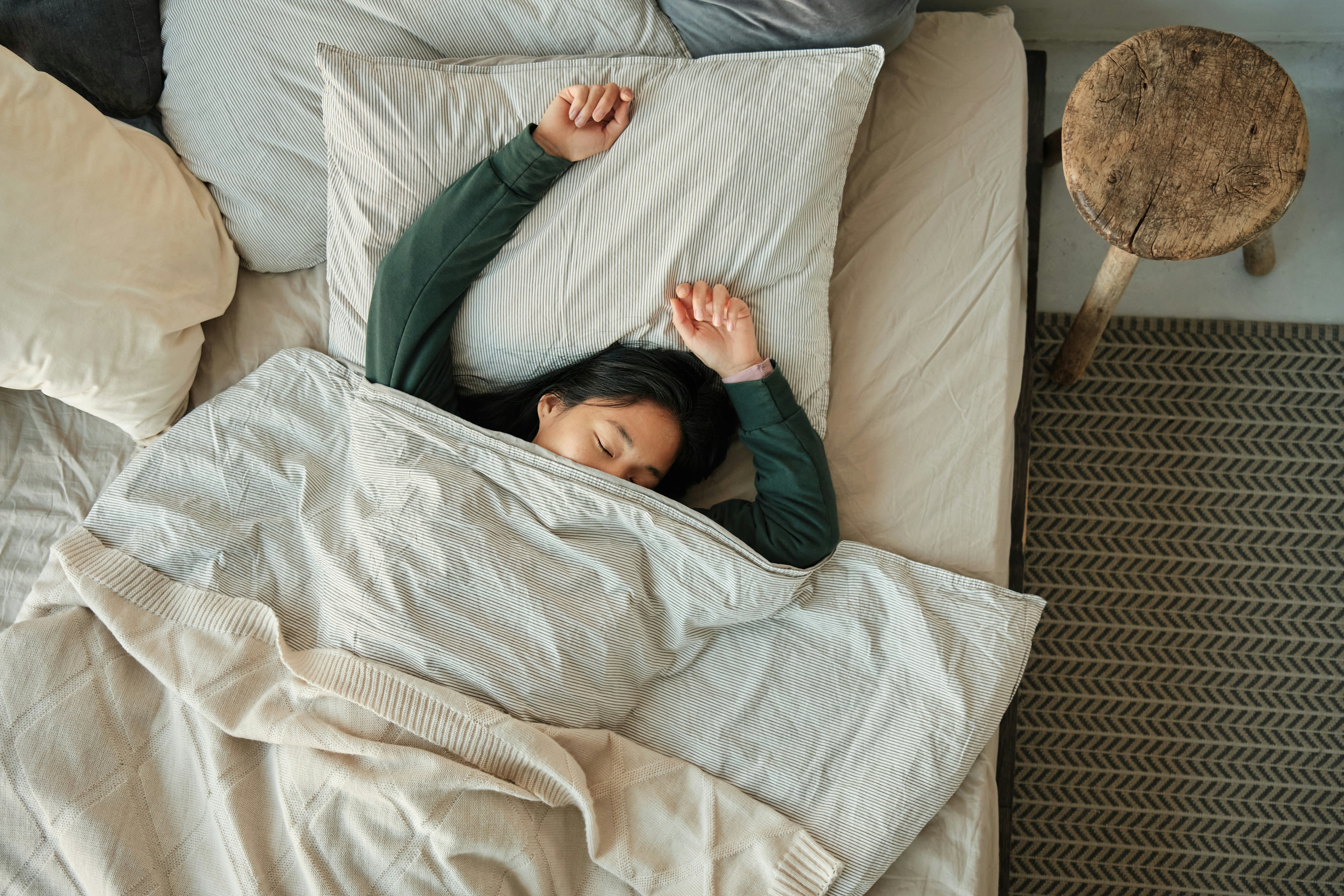 Woman sleeping with sheets covering her