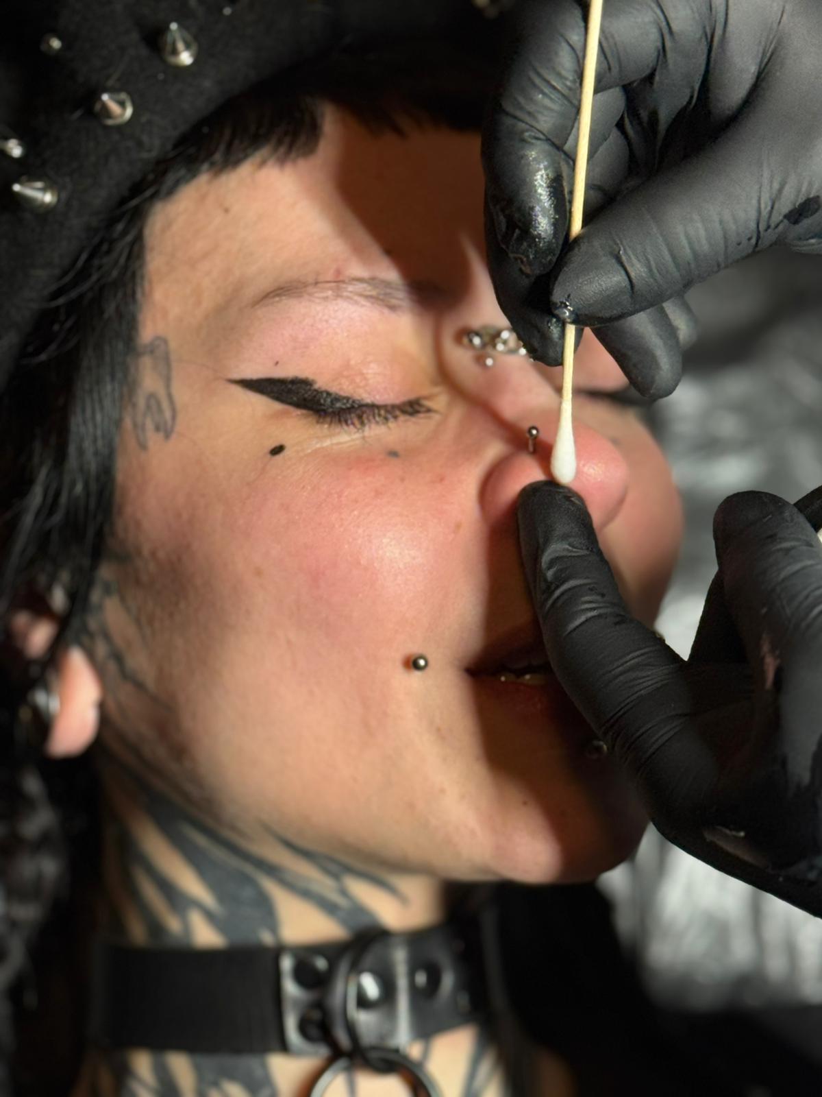 Getting ready to pierce at calavera ink berlin Tattoo Studio Reception Area Prenzlauer Berg