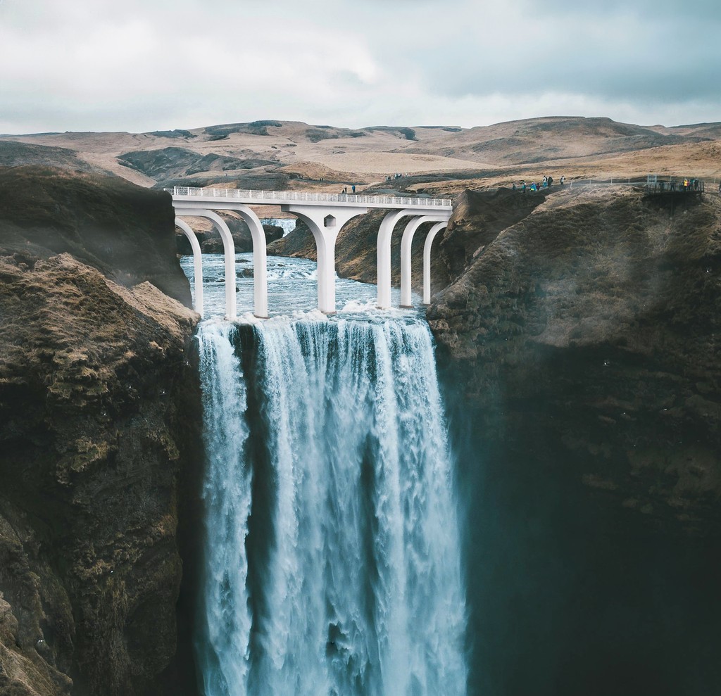 A monumentalist walkway over Icelandic waterfall