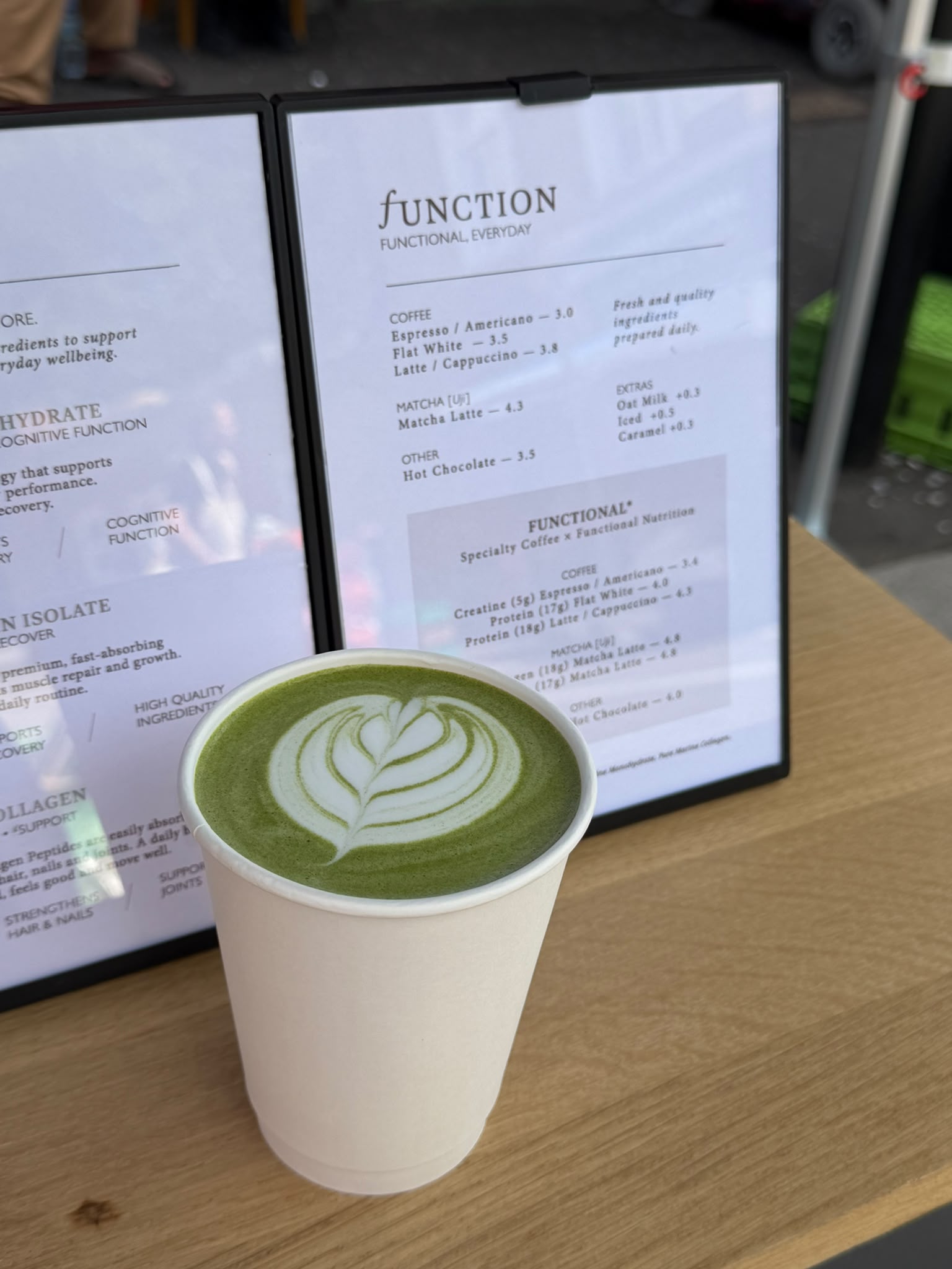 Minimal green matcha drink in a café setting