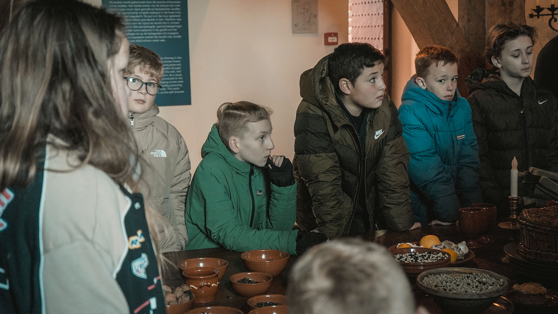 Kinderen luisteren aandachtig tijdens een rondleiding op Slot Loevestein