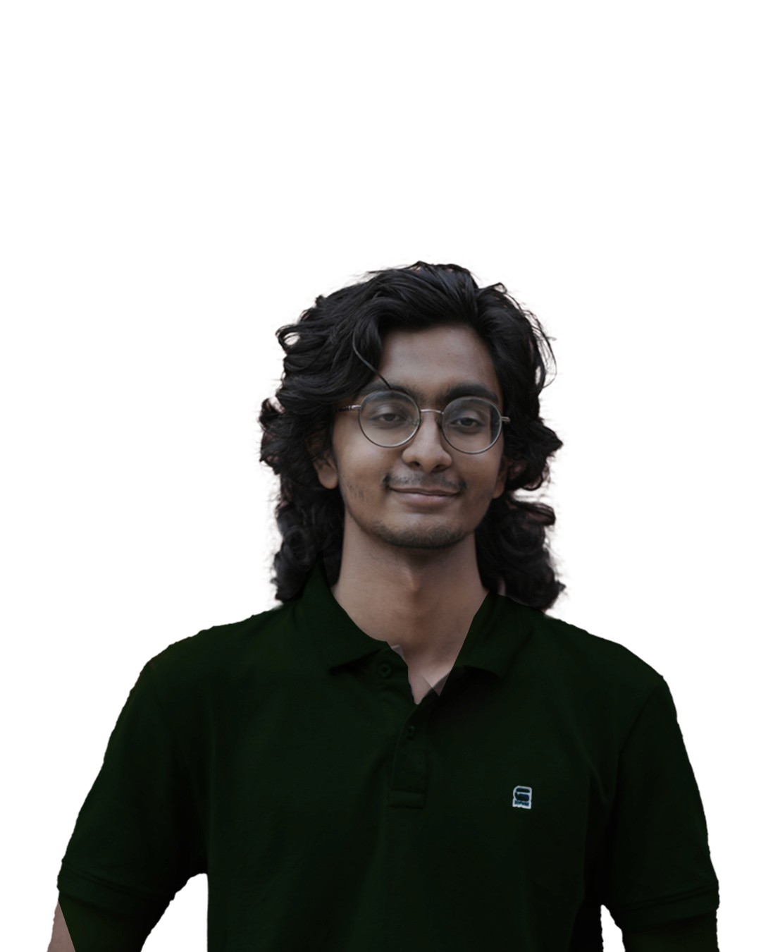 Asian man with glasses in a creative workspace, surrounded by colorful abstract art and stationery on a cluttered desk.