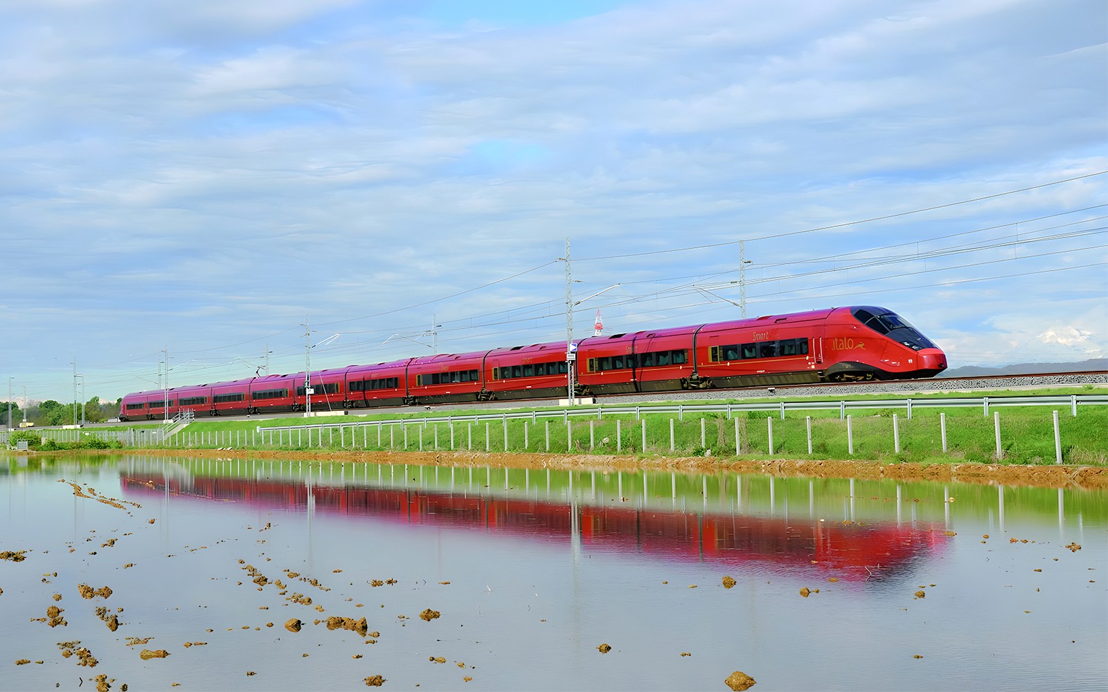 High-speed train traveling through countryside between Rome and Florence.