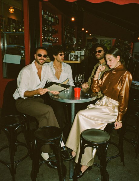 Four friends at a bar table