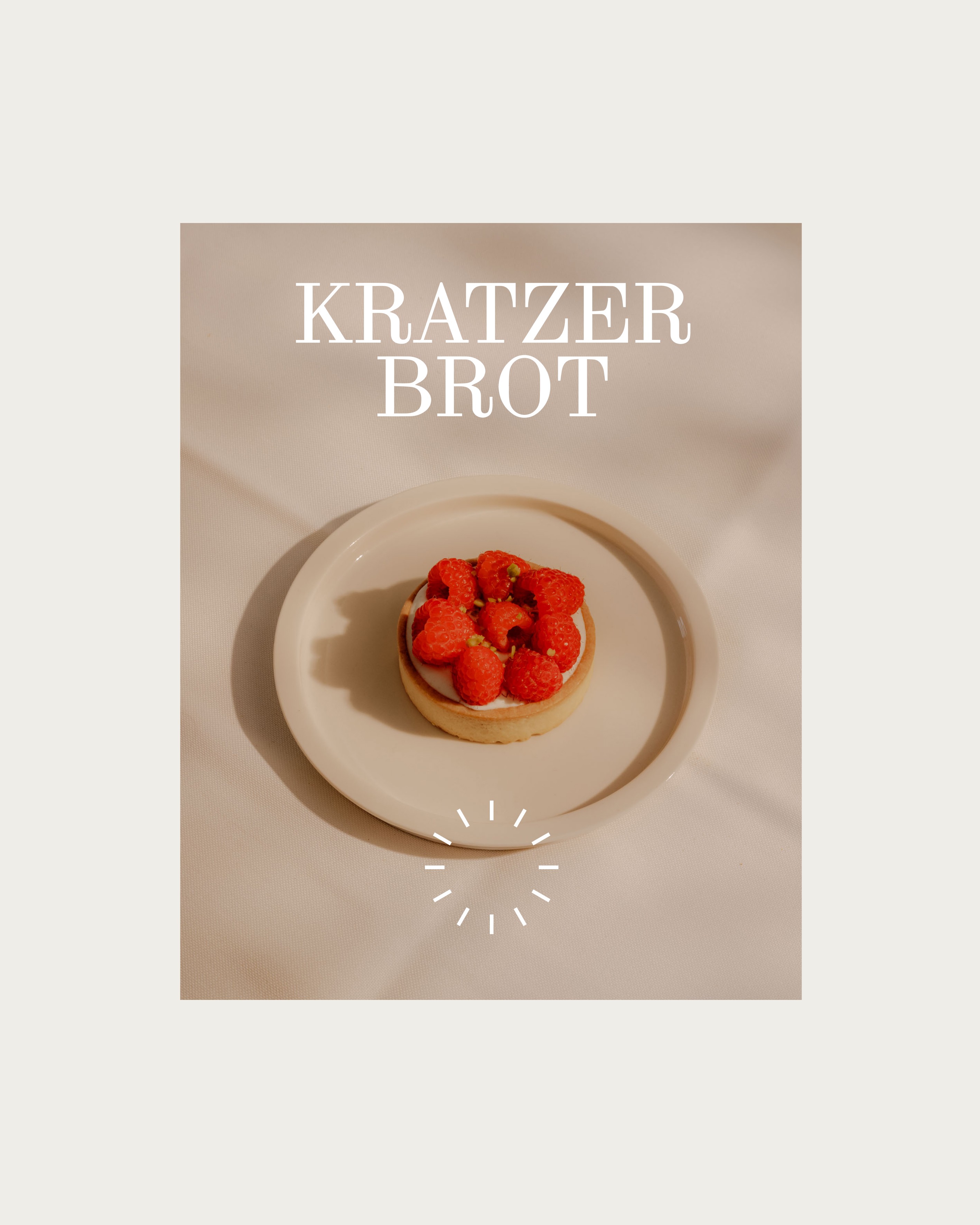 A picture of a raspberry dessert on a small beige plate with the logo and wordmark of Kratzer Brot on top. 
