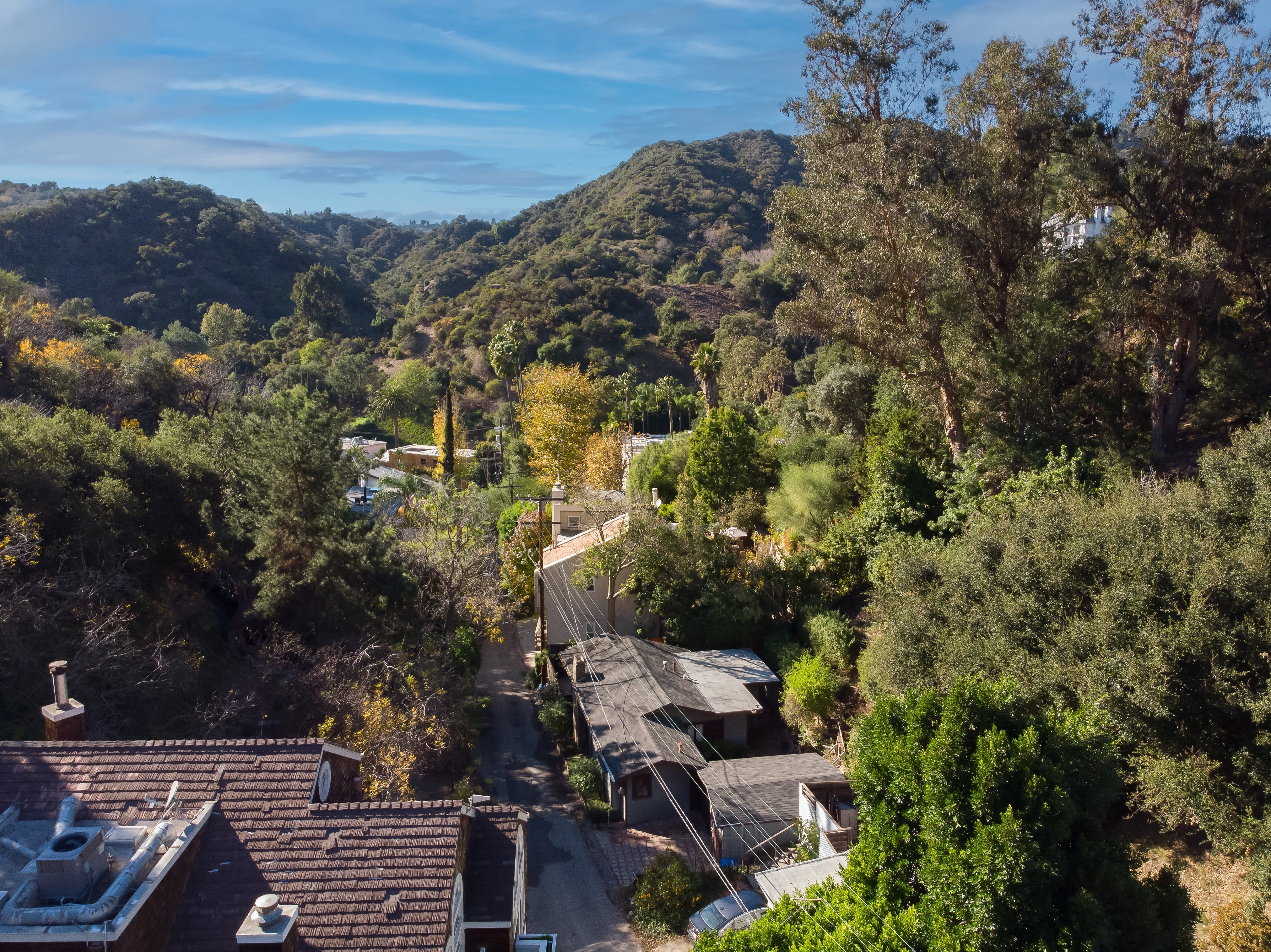 Modern hillside house with stilts and glass railing