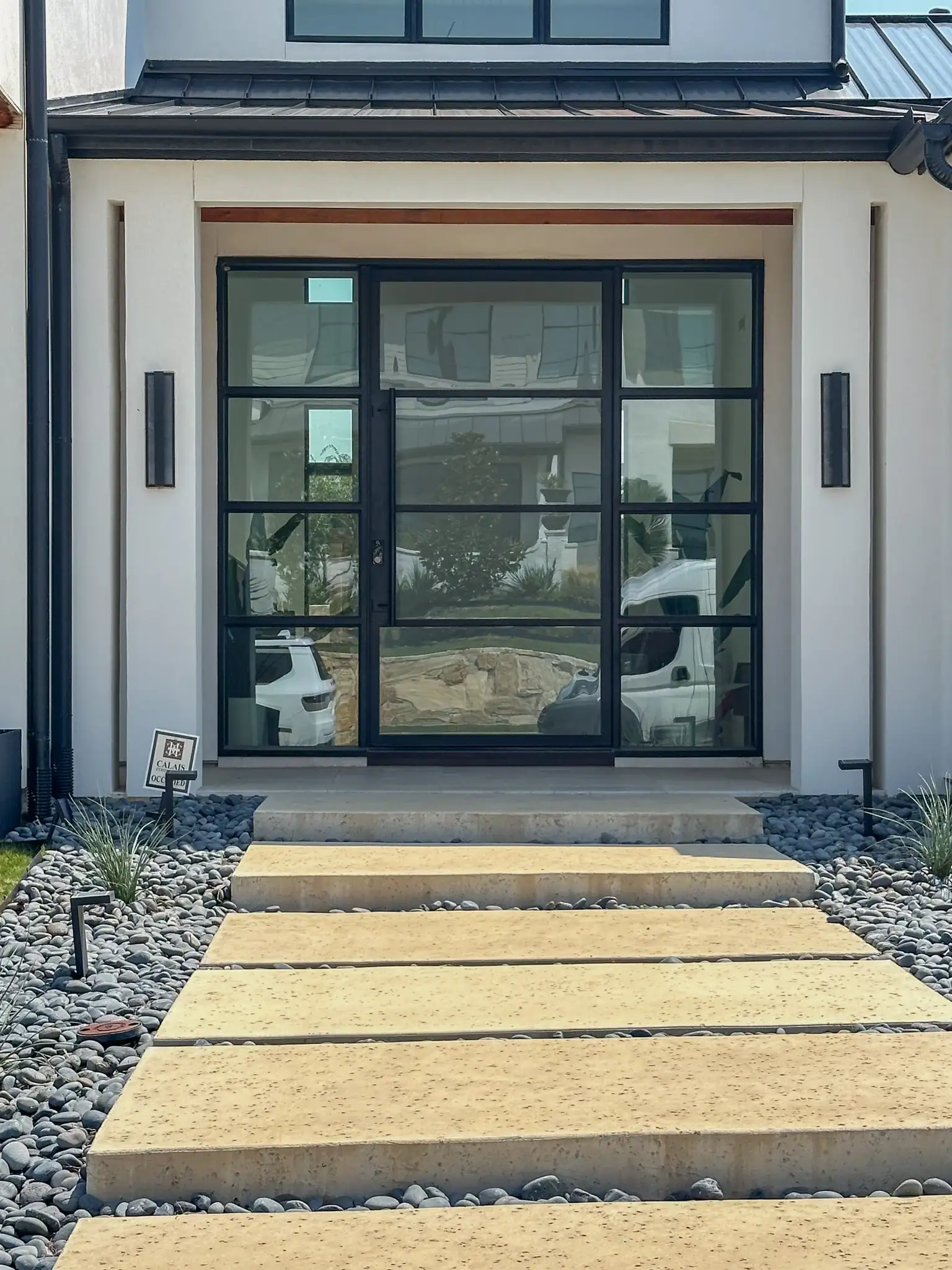 4 lite pivot door with side lites installed by M2 Metals Iron Doors