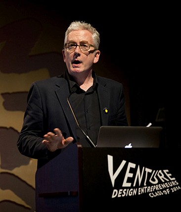 an old man dress in black is giving a speech