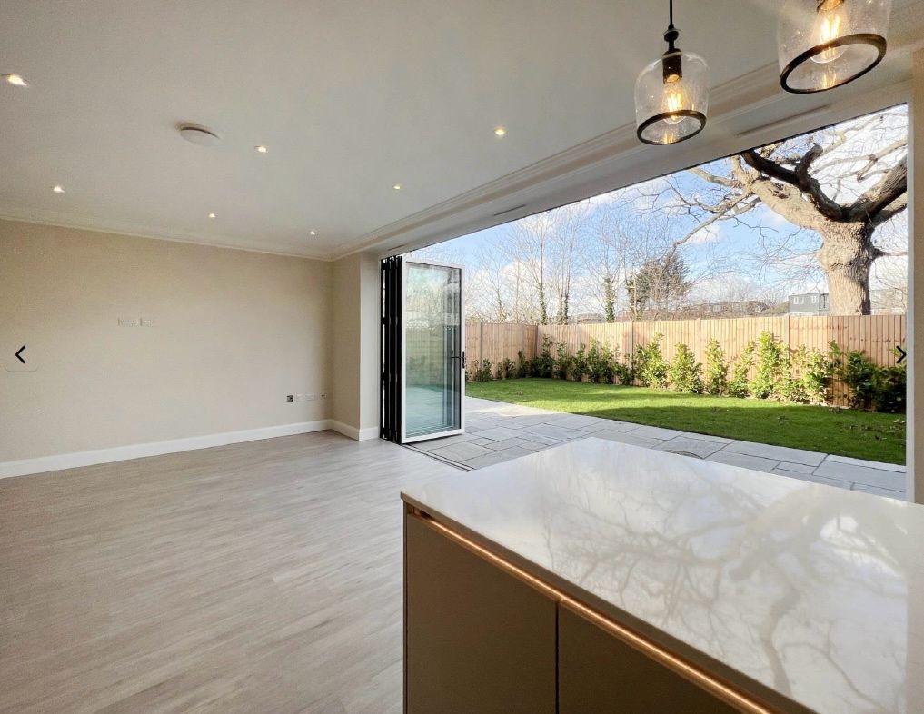 Open-plan living space with bi-fold doors opening onto the garden
