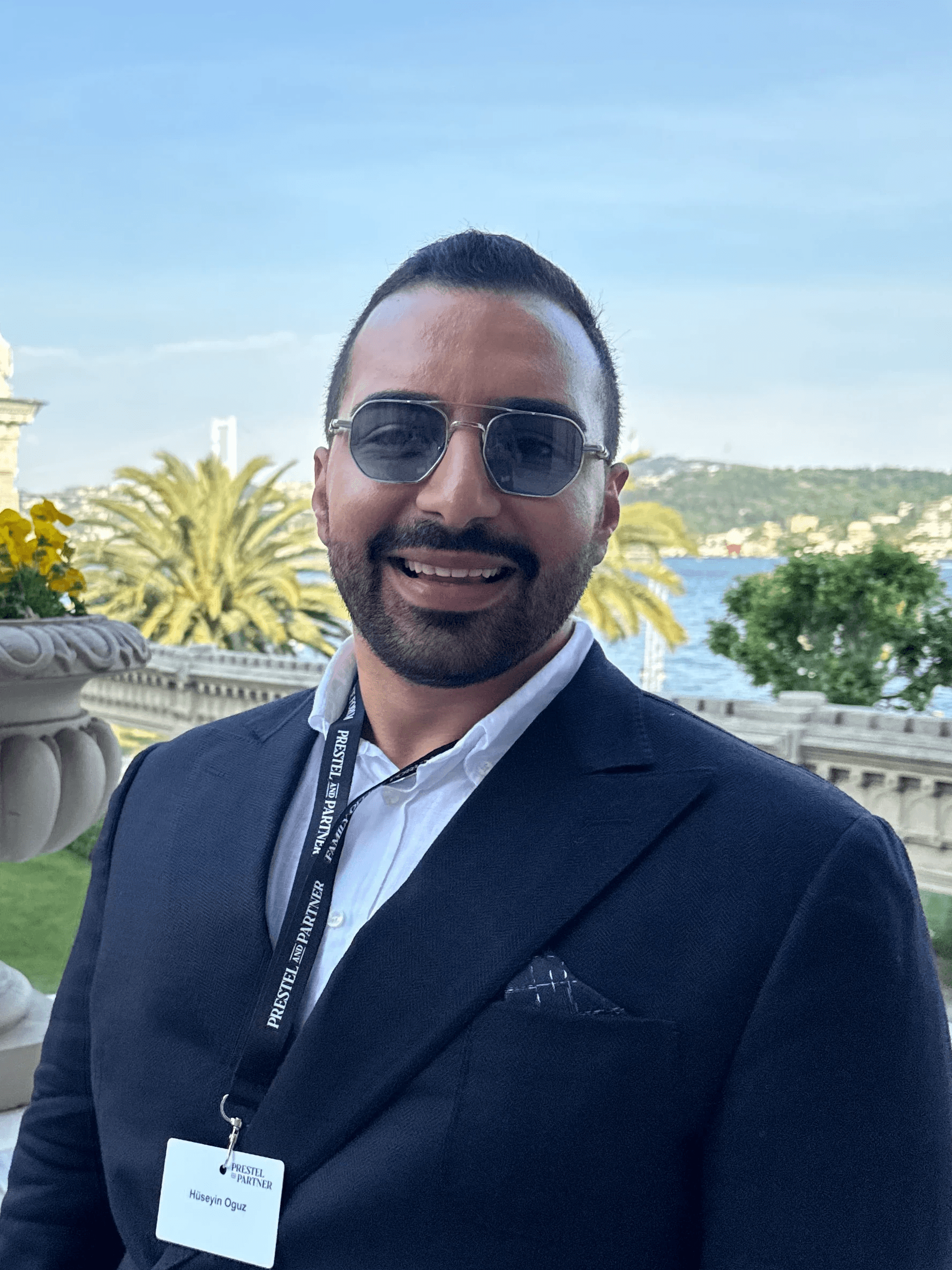 A young person with long, wavy hair sits in front of a plain background, looking directly at the camera.