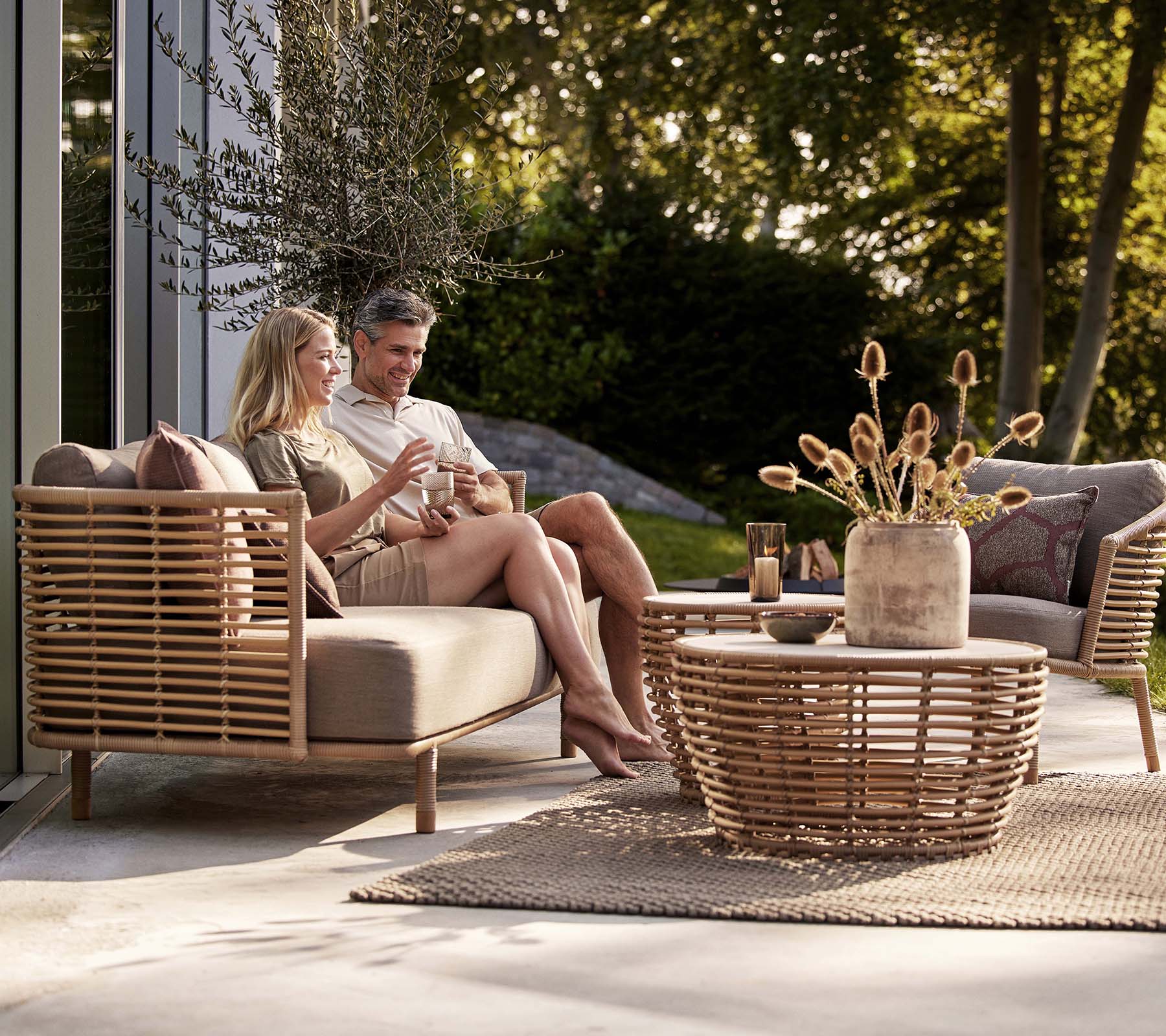 Handwoven rattan lounge chair with natural finish, designed for indoor and outdoor comfort