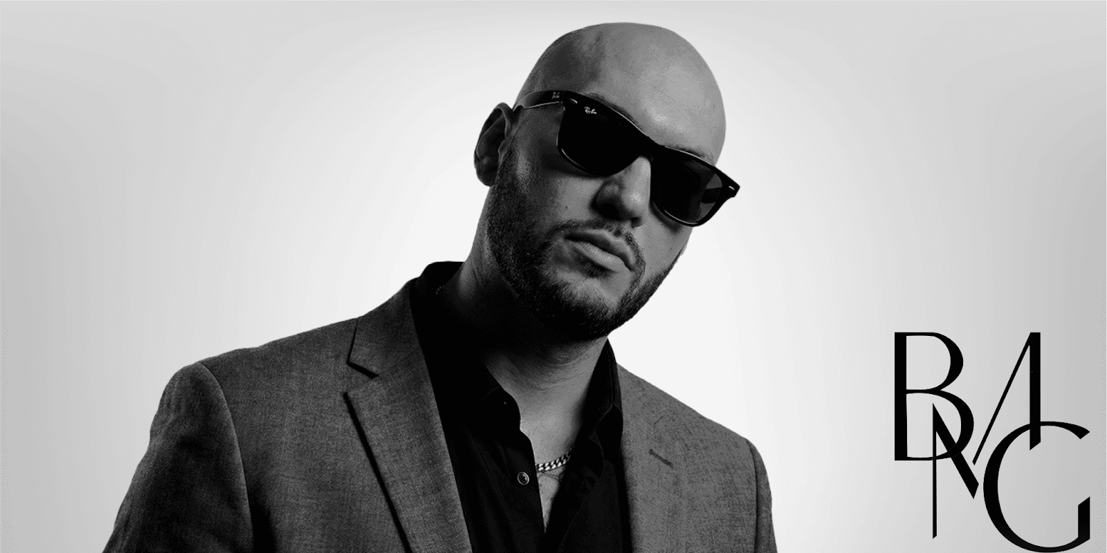 Tim from Brave Money, exuding confidence in a sleek suit and sunglasses, symbolizing success and resilience.