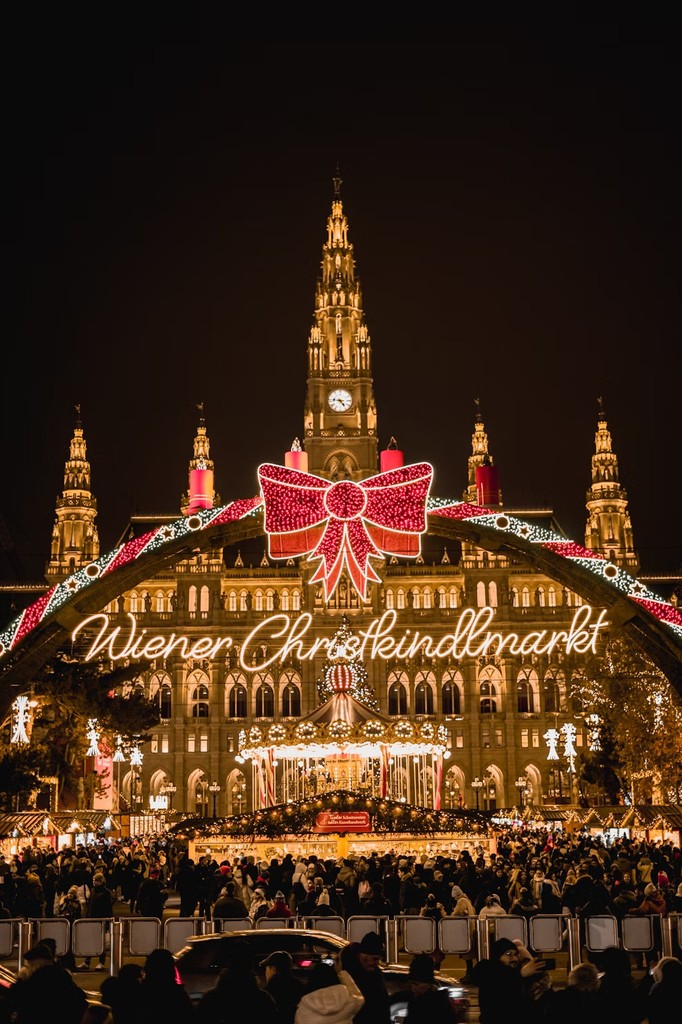 a group of people walking around a christmas market