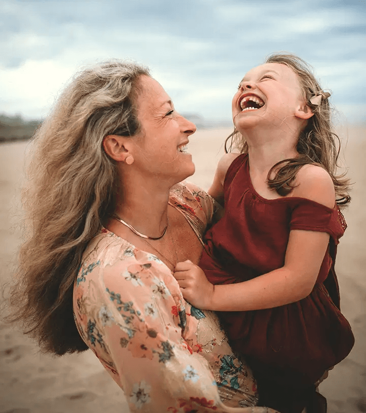 Mother and daughter laughing during a warm, playful family session in San Diego.