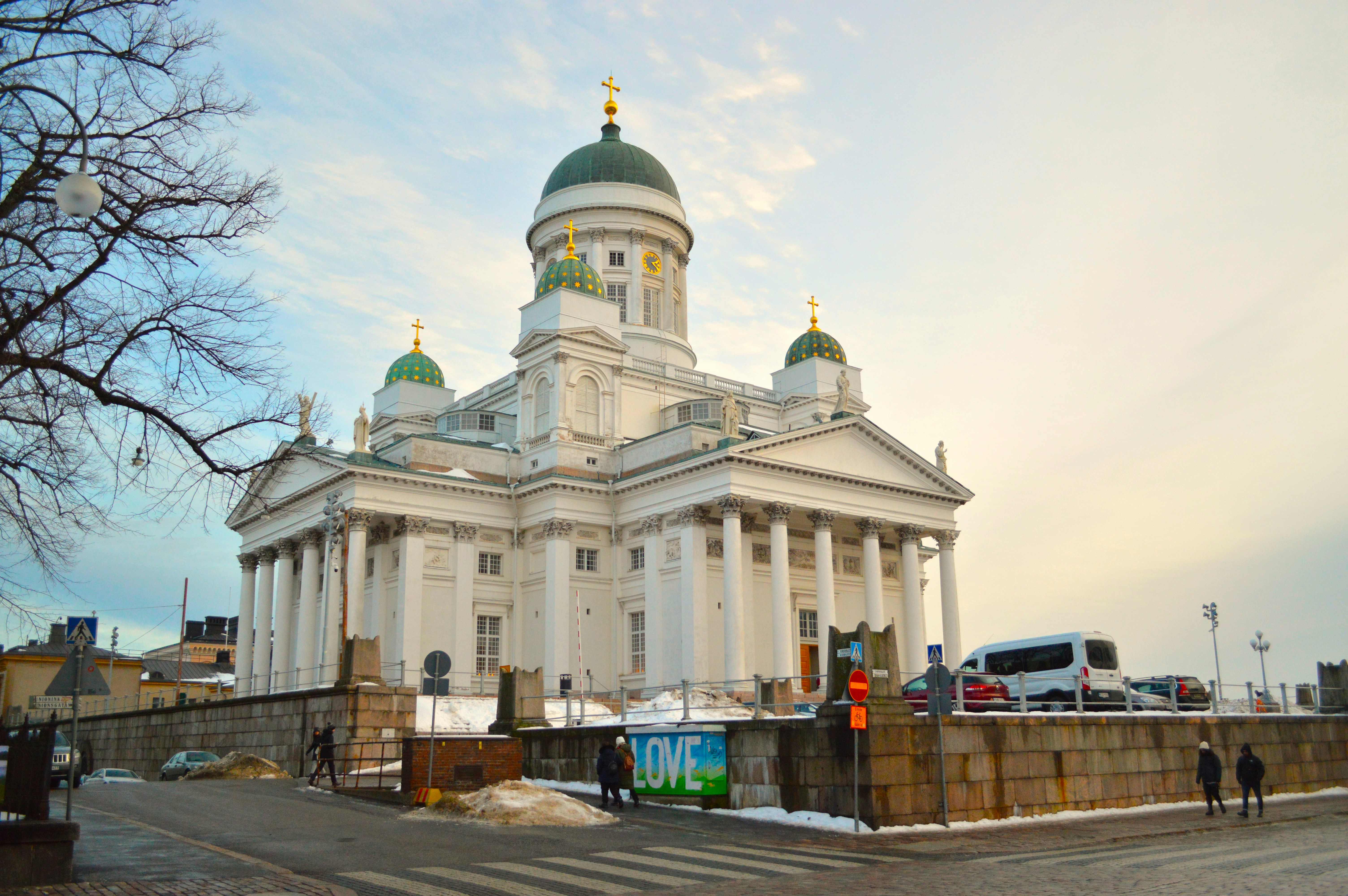 a large white building with a green dome