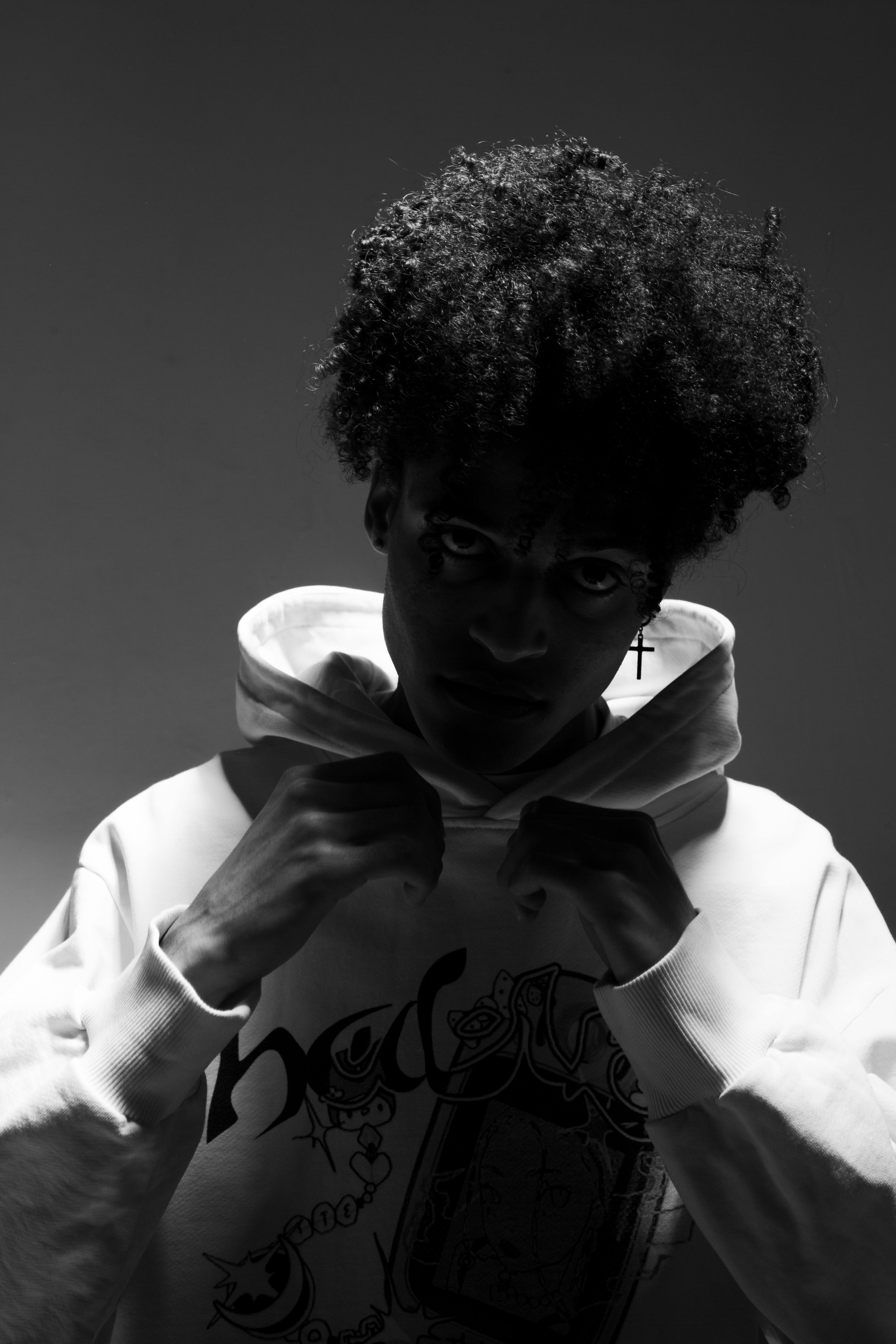 Man Posing Holding His Hoodie Sweater