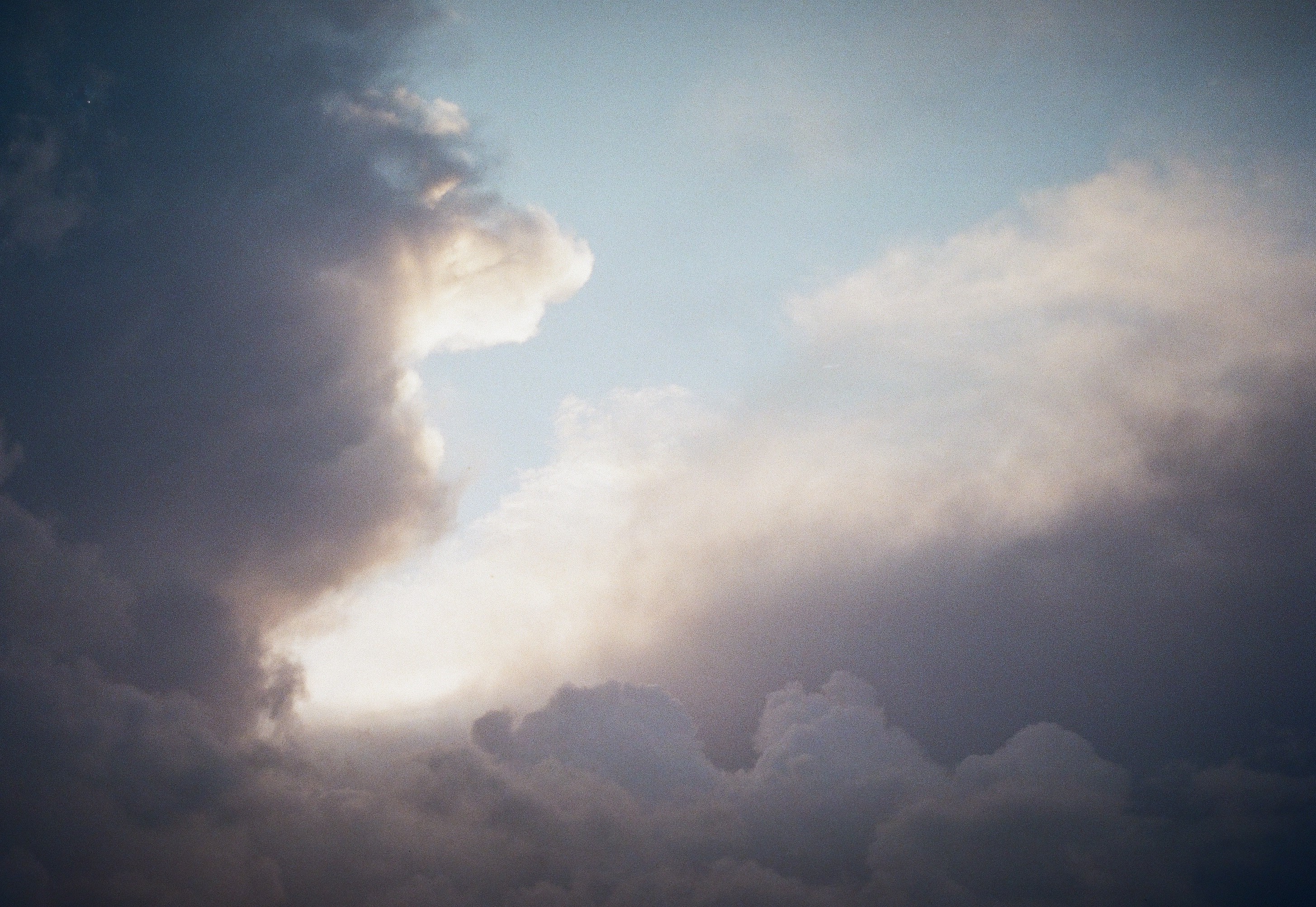 Silhouette of a person's face behind a wet surface.