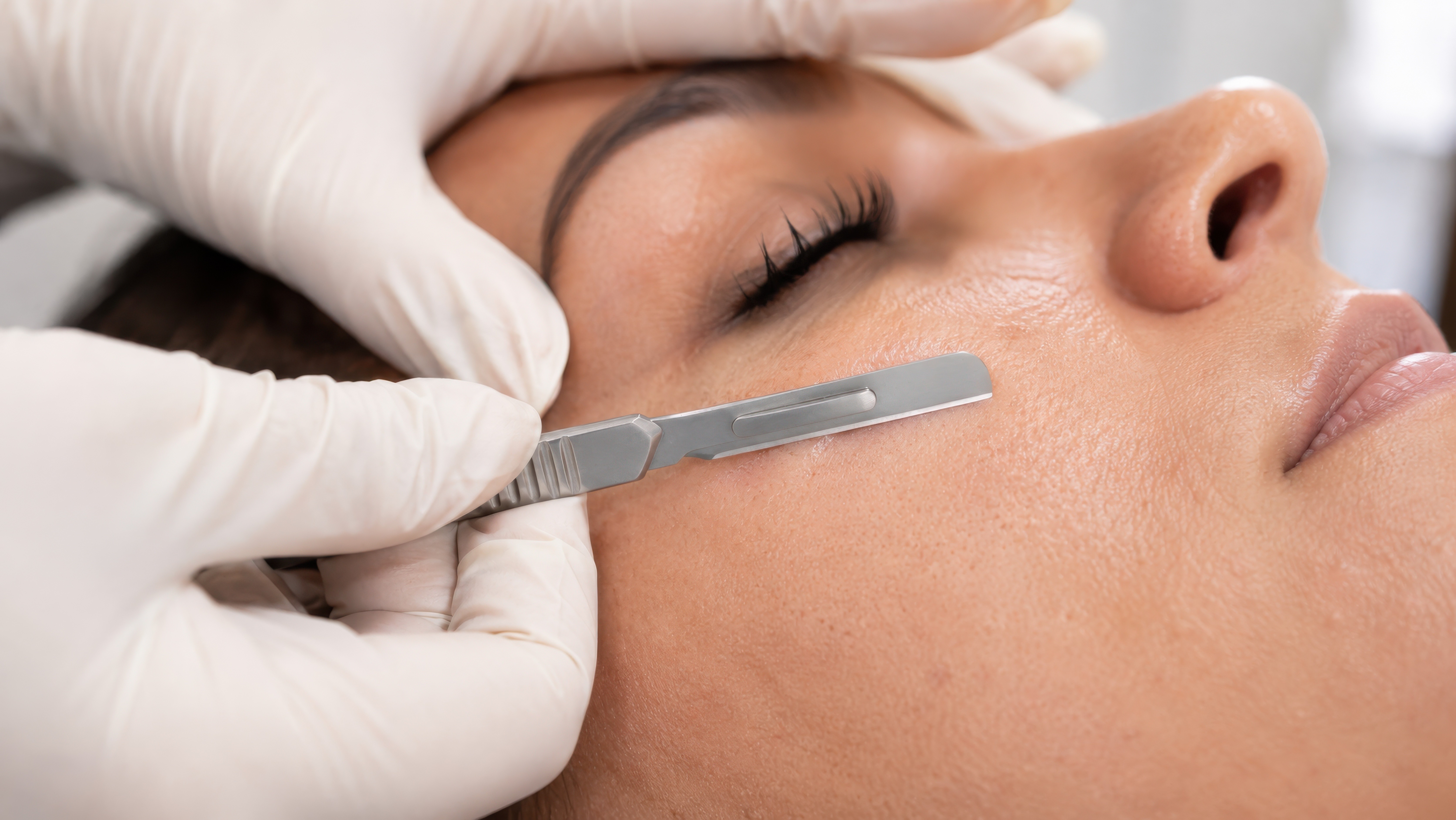 A skincare therapist providing a facial treatment