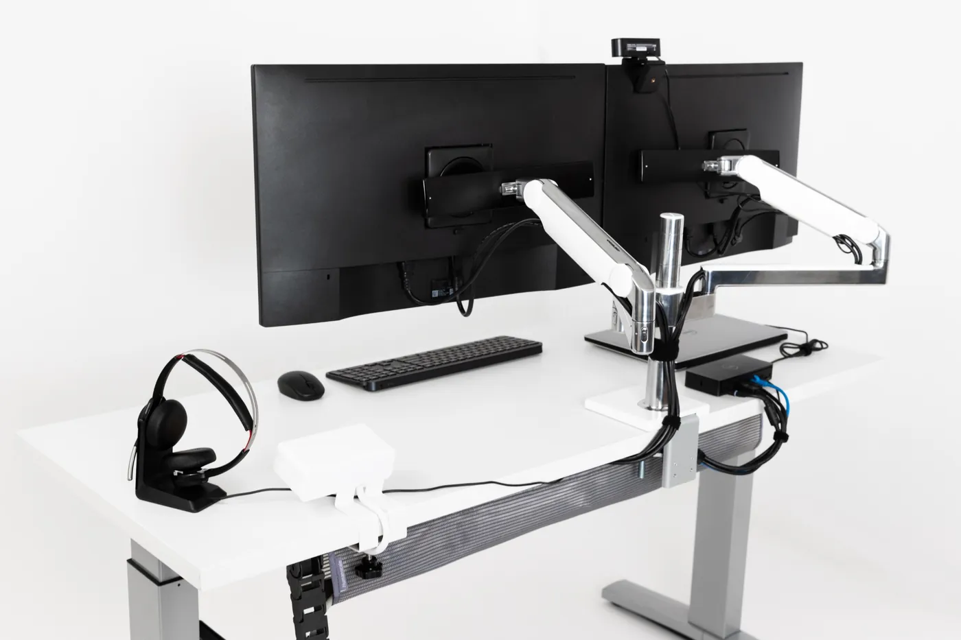 Professional dual monitor installation with ergonomic mounting and clean cable management in office workspace.