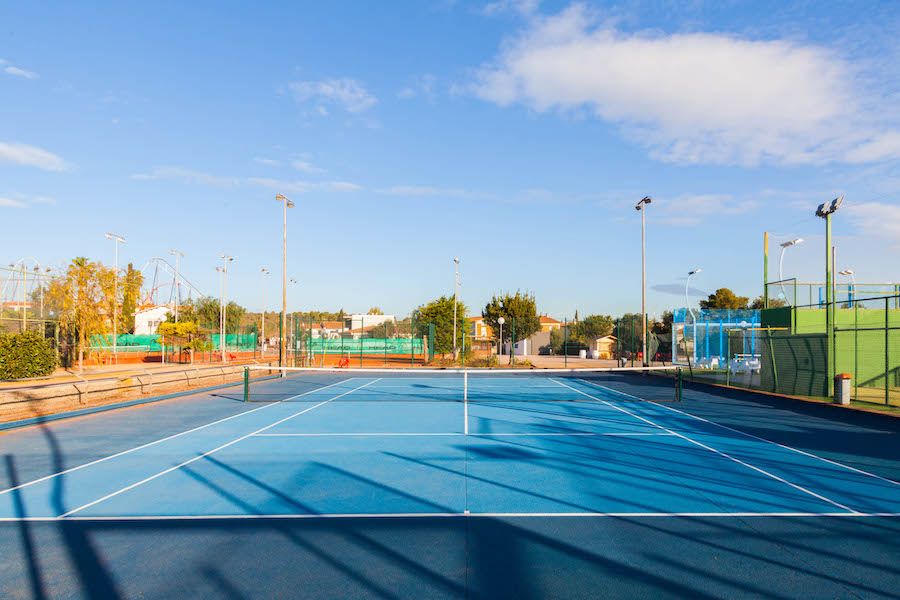 gold and black bottle on white wooden table