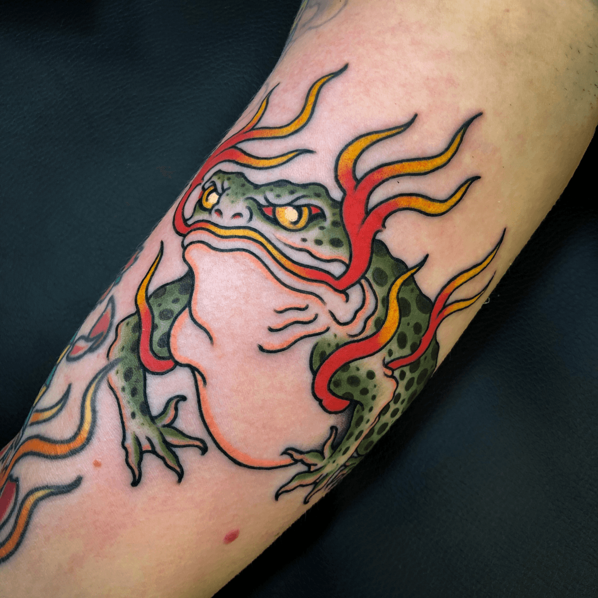 color tattoo of a frog with flames