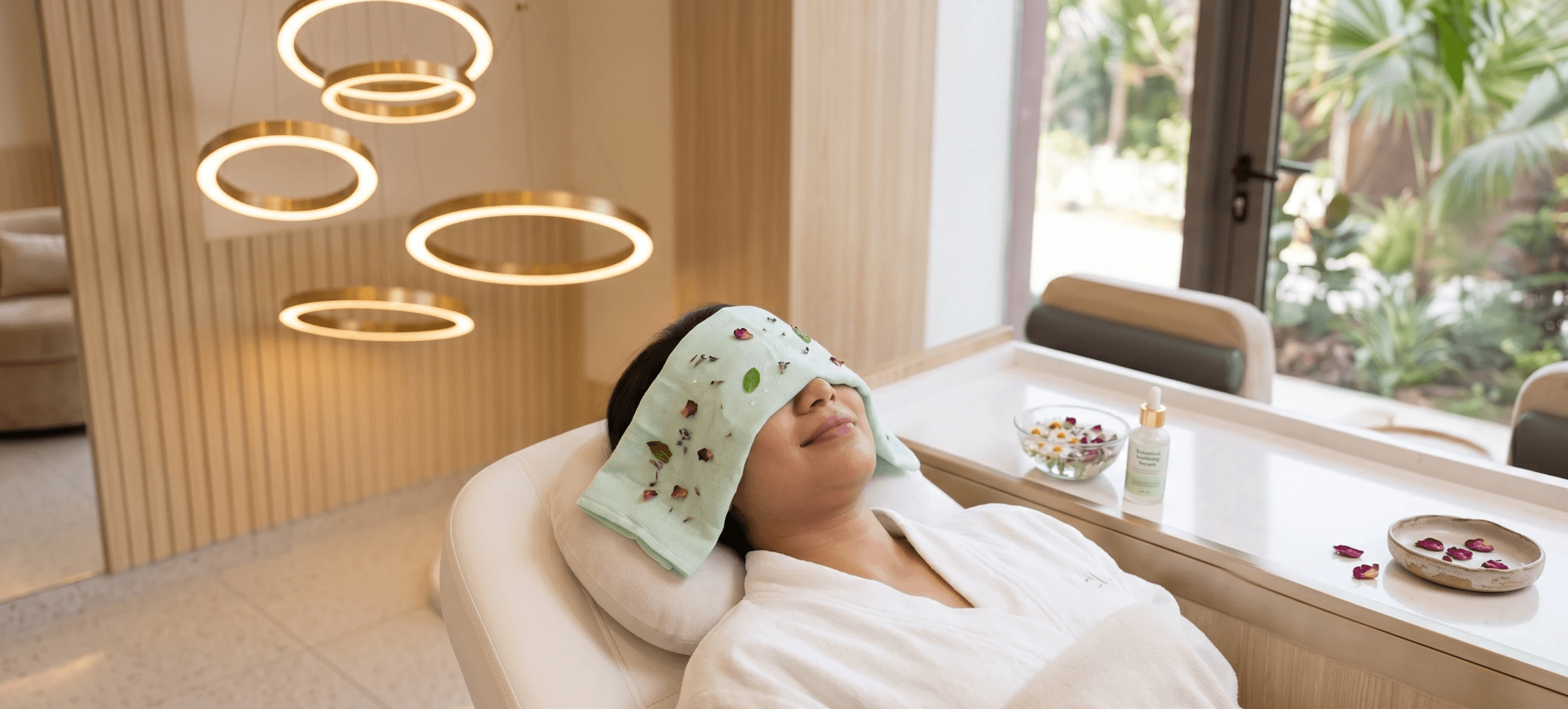 A patient relaxing with a chilled botanical-infused compress over their face to soothe the skin and reduce any temporary warmth.