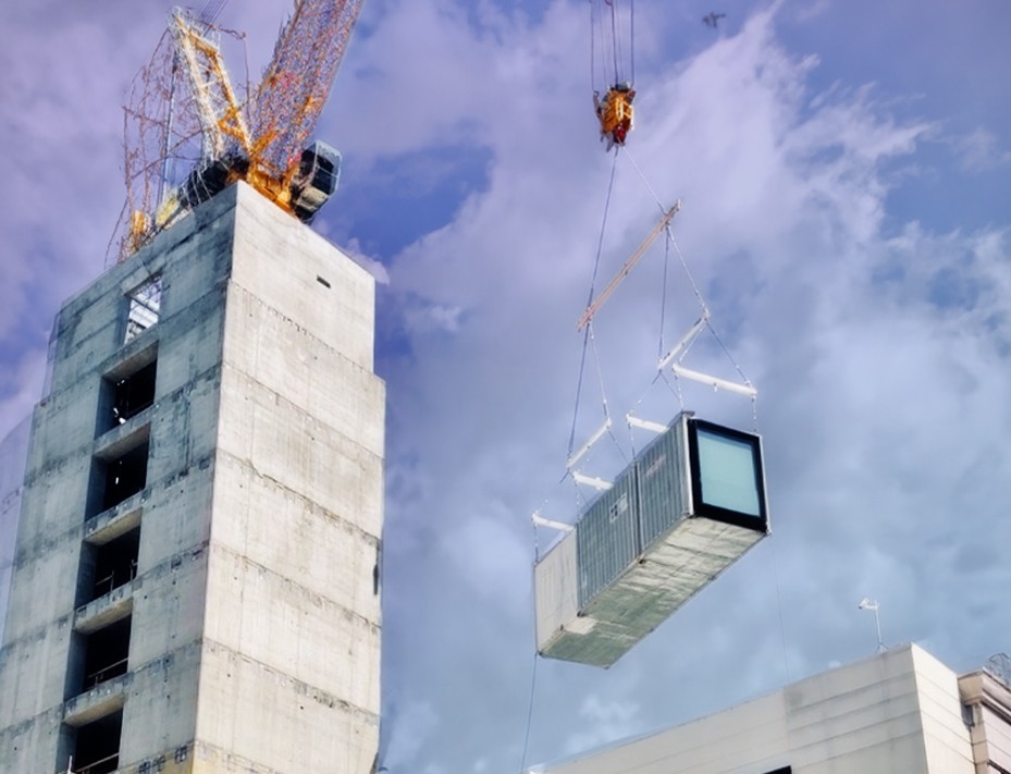 A crane hoists a modular unit at citizenM DTLA, exemplifying cutting-edge urban design in Los Angeles.