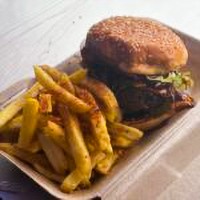 Woman smiling holding her head