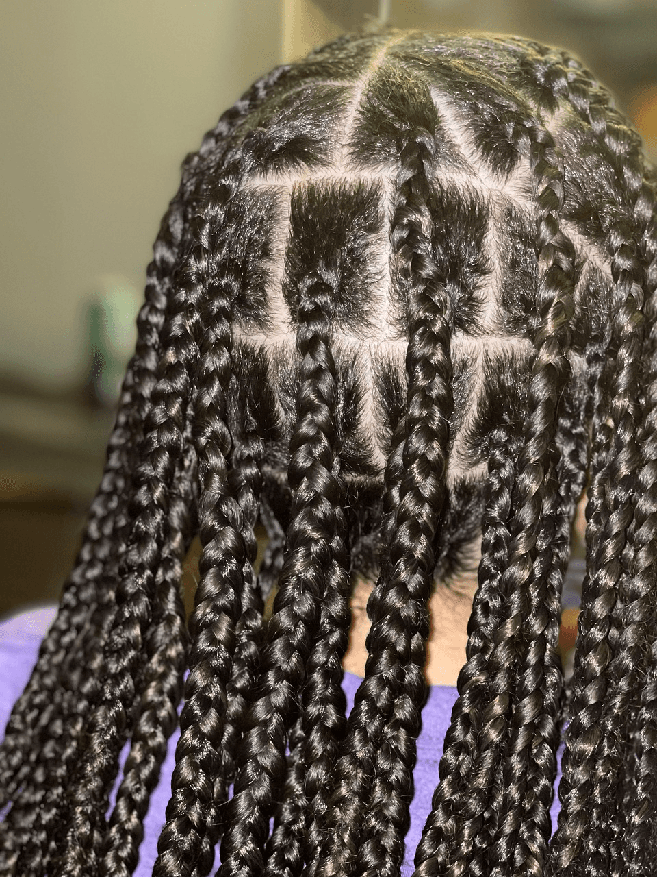 Close-up of knotless boho braids with neat square parting