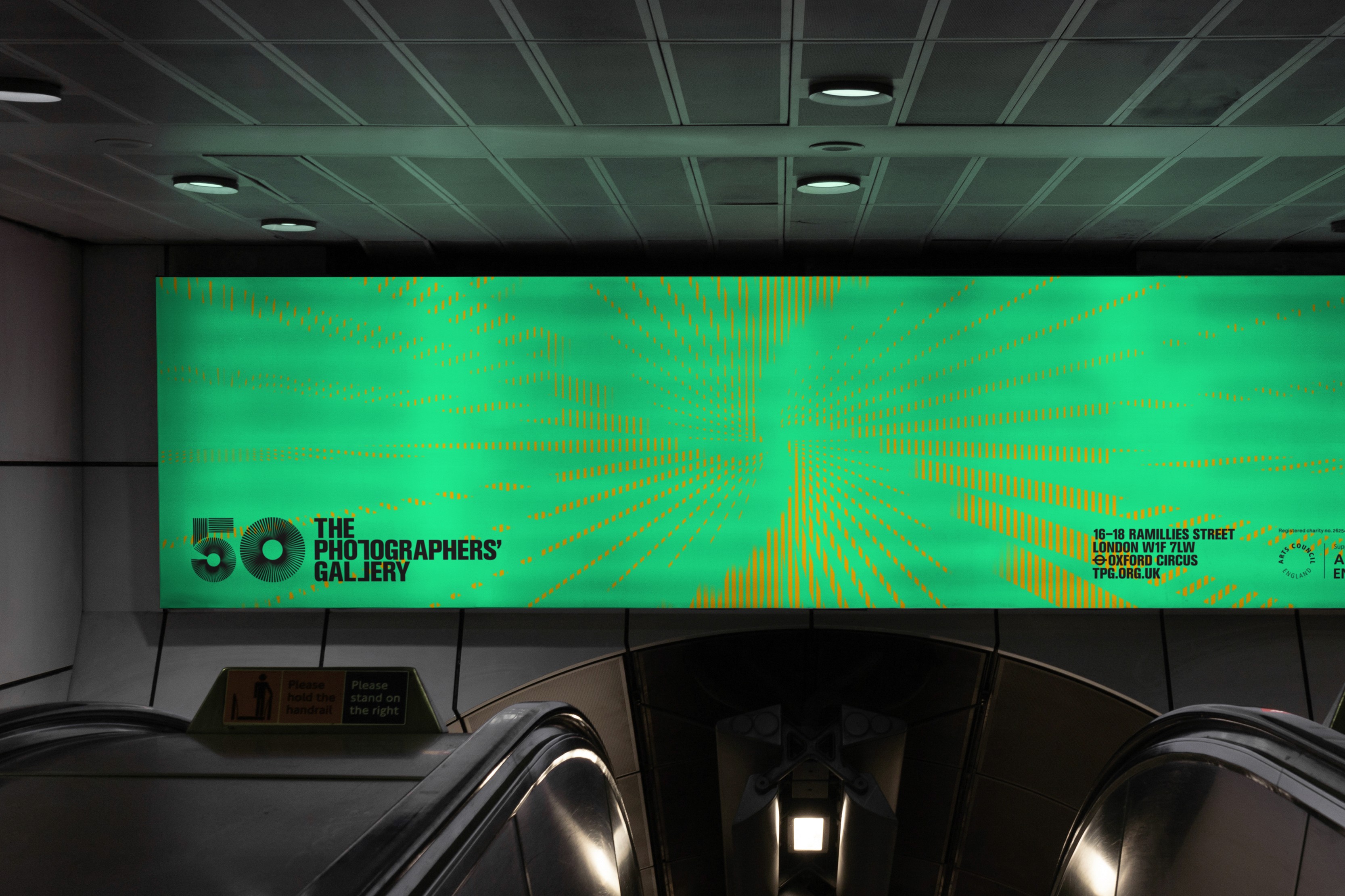 A modern cinema screen displays a vibrant green advertisement, viewed from the seating area.