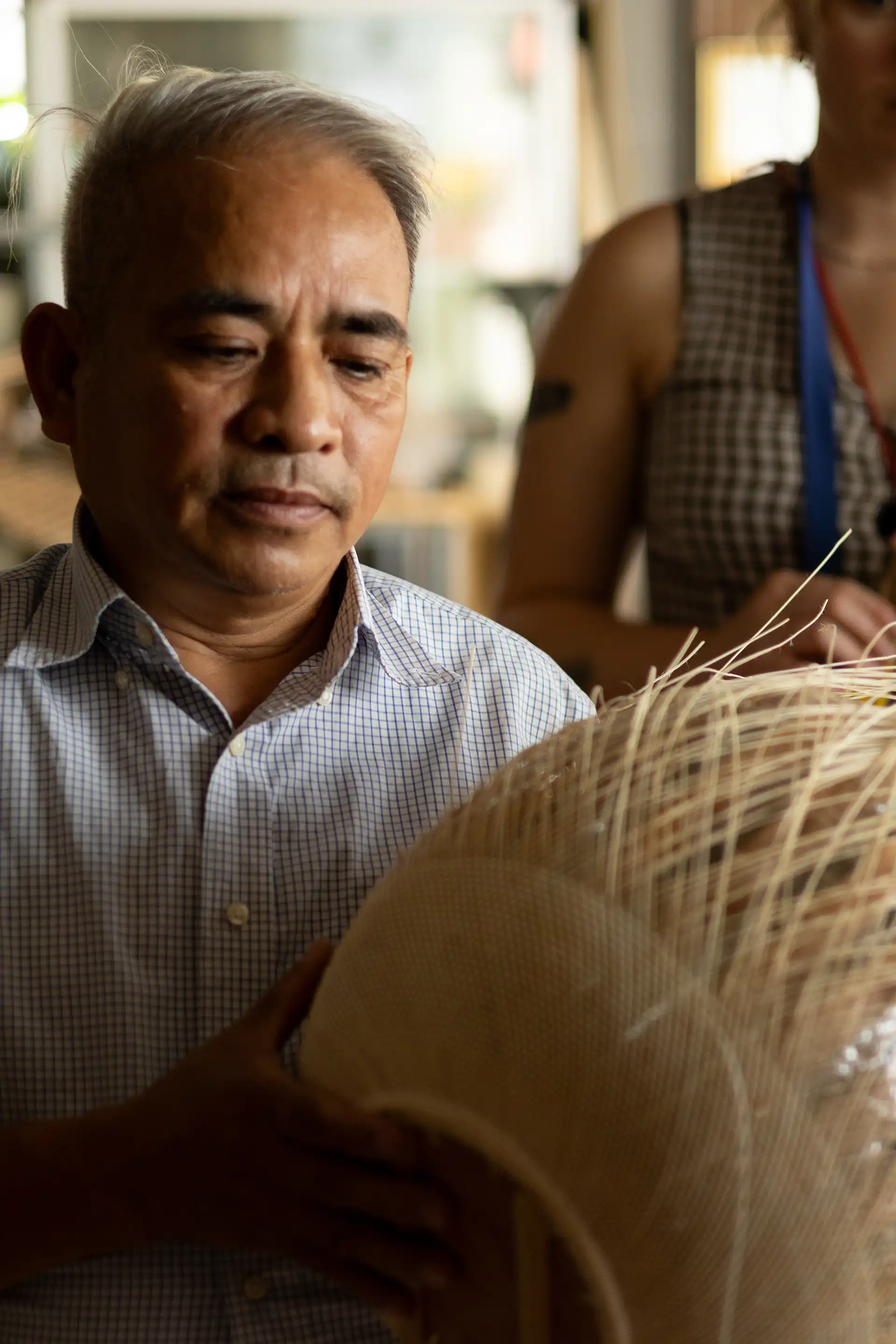 Portrait of a rattan producer holding his product
