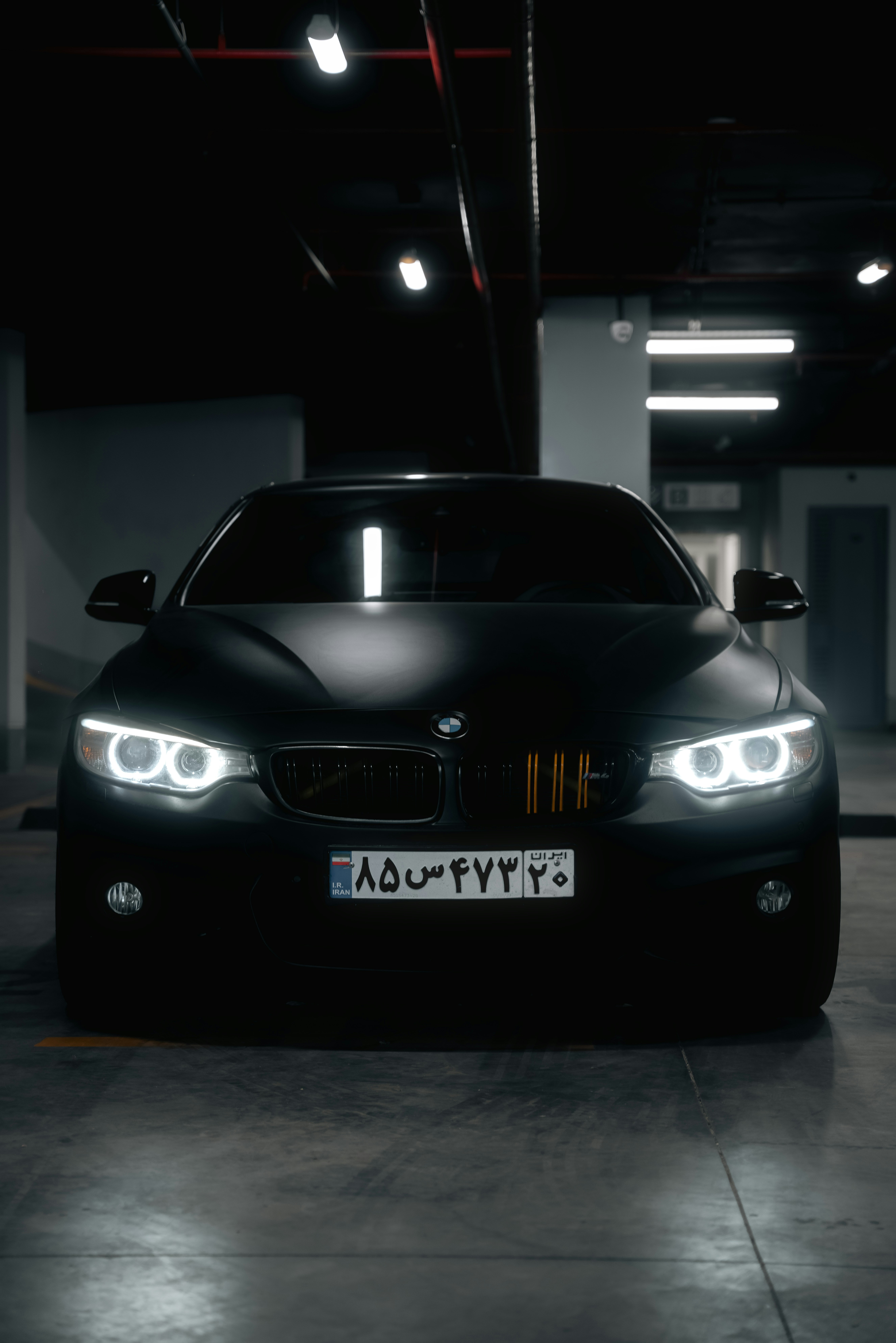 a black car parked in a parking garage