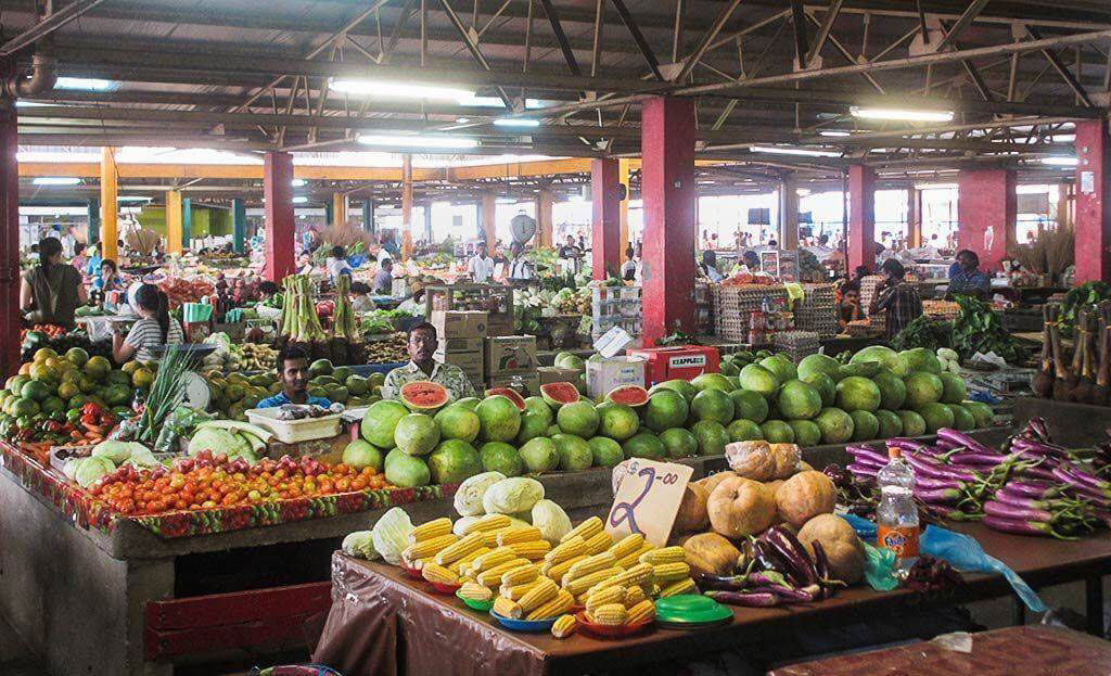 An authentic fruit market in Fiji Displaying vibrant  fresh watermelons, corn, eggplants, and an assortment of local produce.