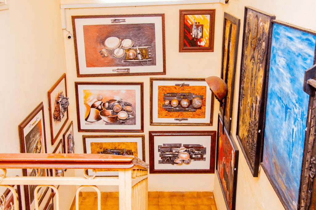 A man admiring a painting in an art gallery.