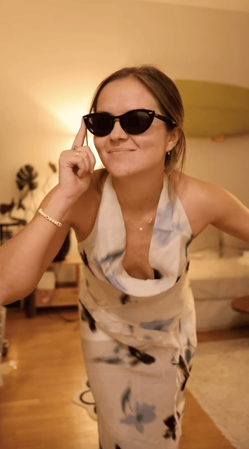 justine de gennes with sunglasses and a dress