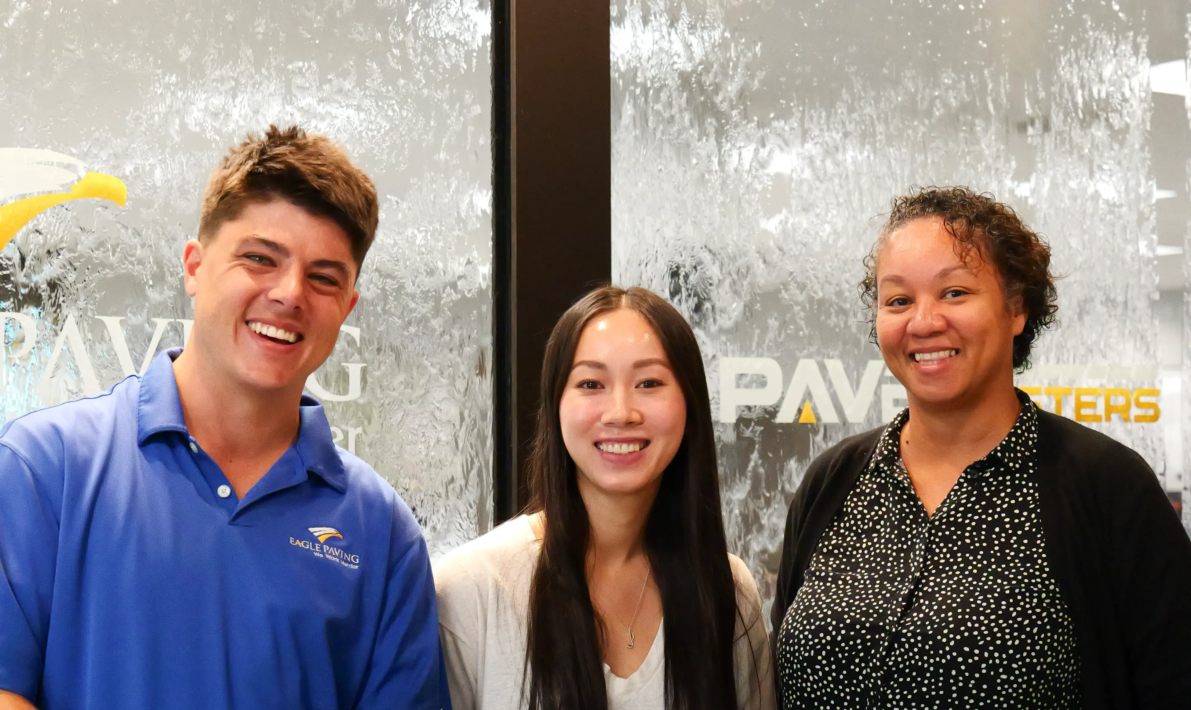 Diverse group of office employees in front of water feature