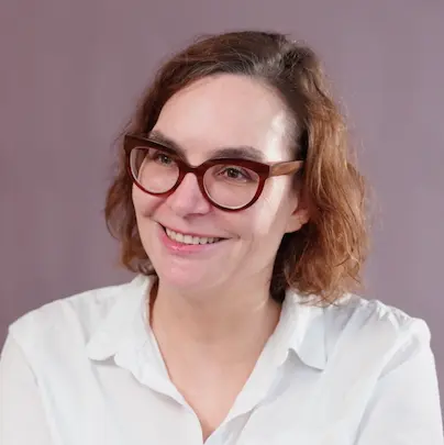 smiling woman wearing white and black pinstriped collared top