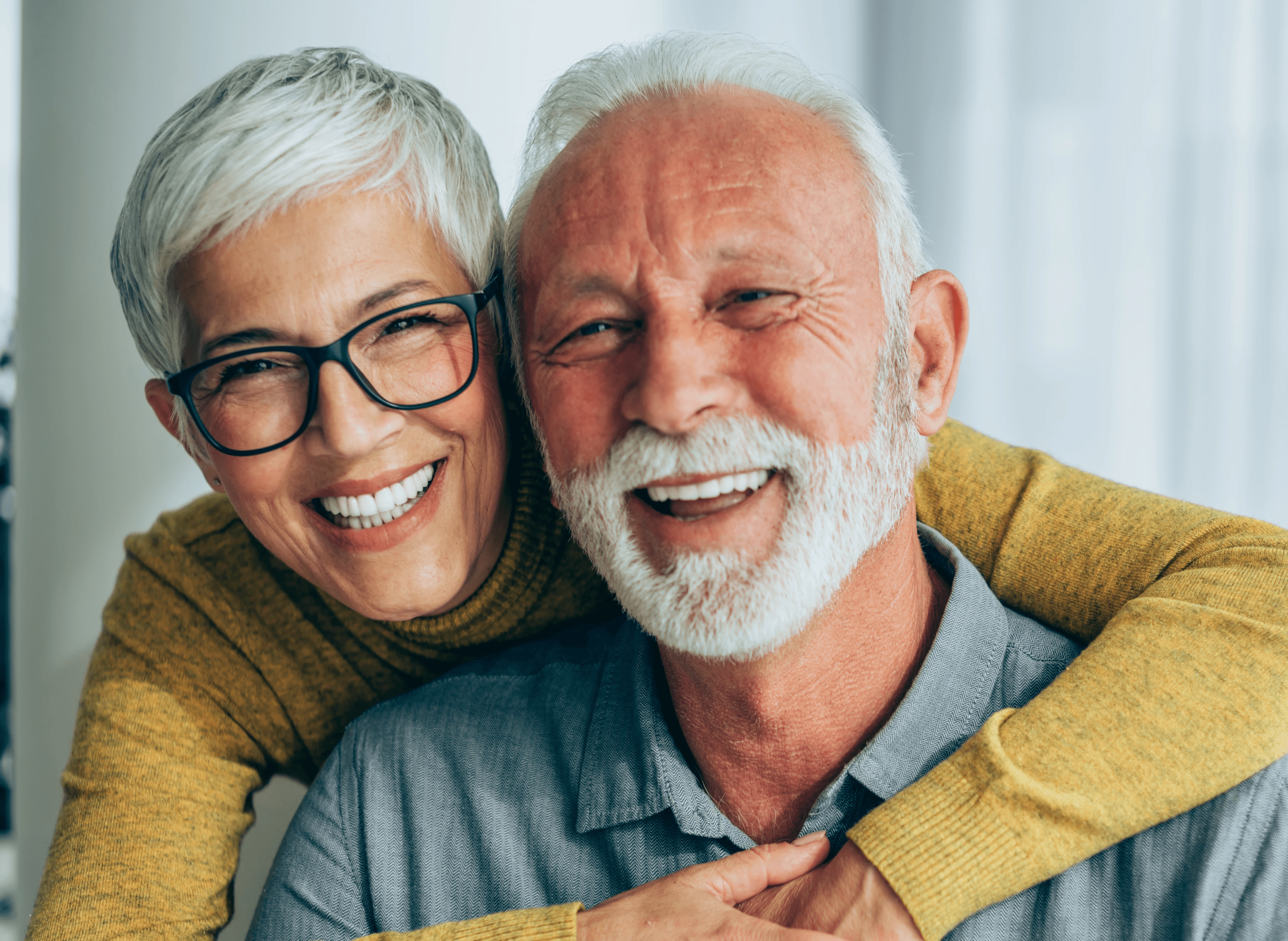 Smiling older couple after dental implant treatment