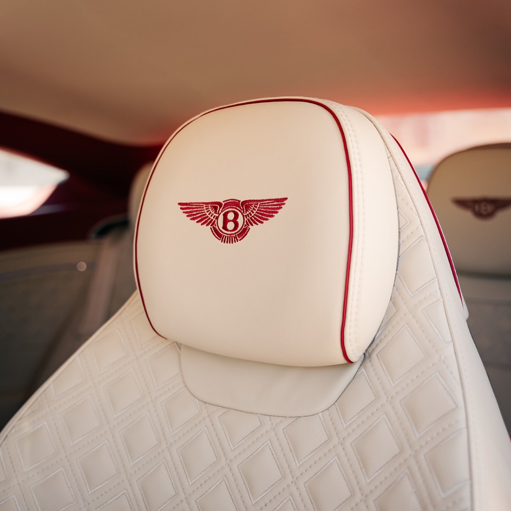 Diamond stitched Bentley headrest with embroidered winged B logo in red stitching