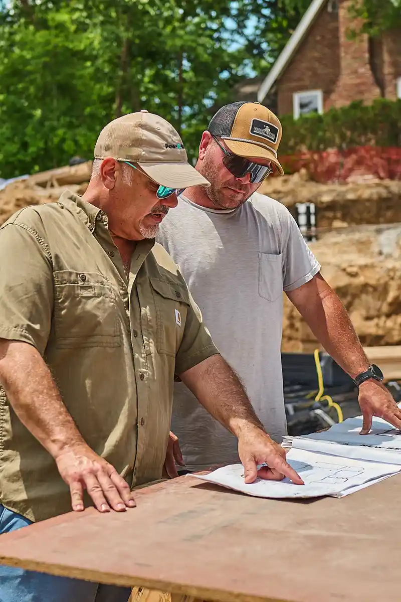 Andy Hobbs on a job site talking with a builder