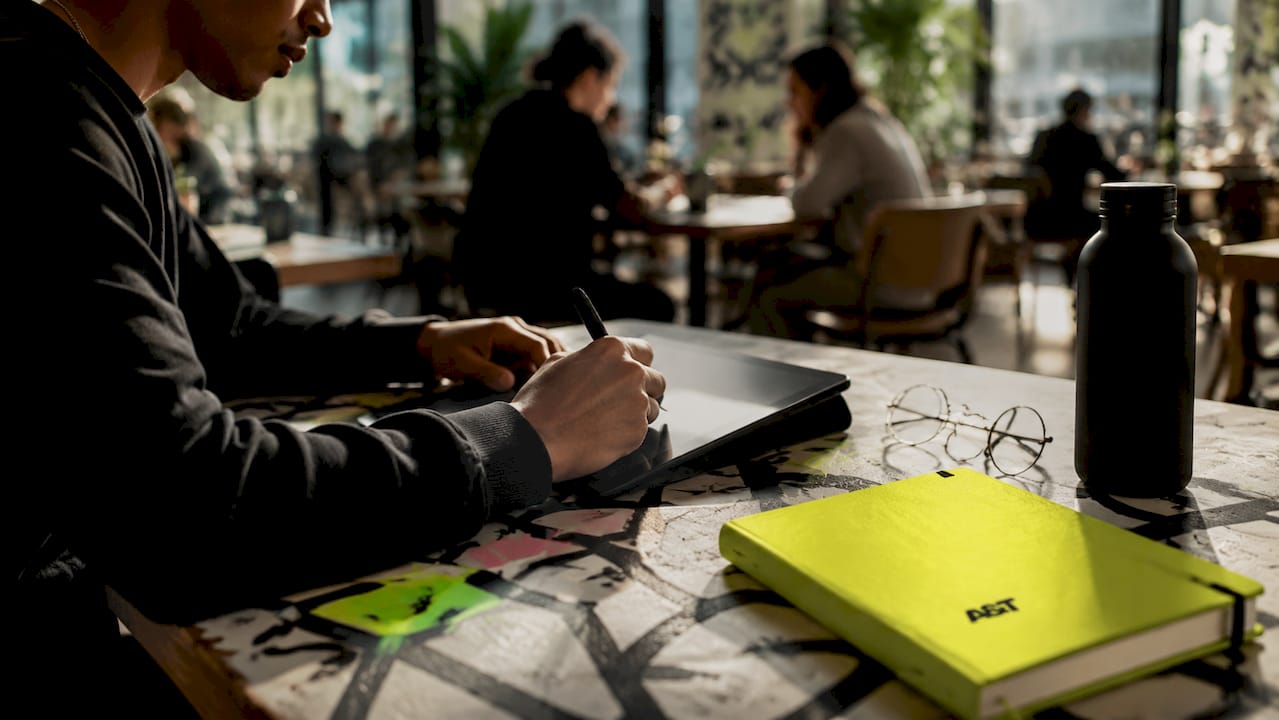 Hands editing digital marketing creative with stylus