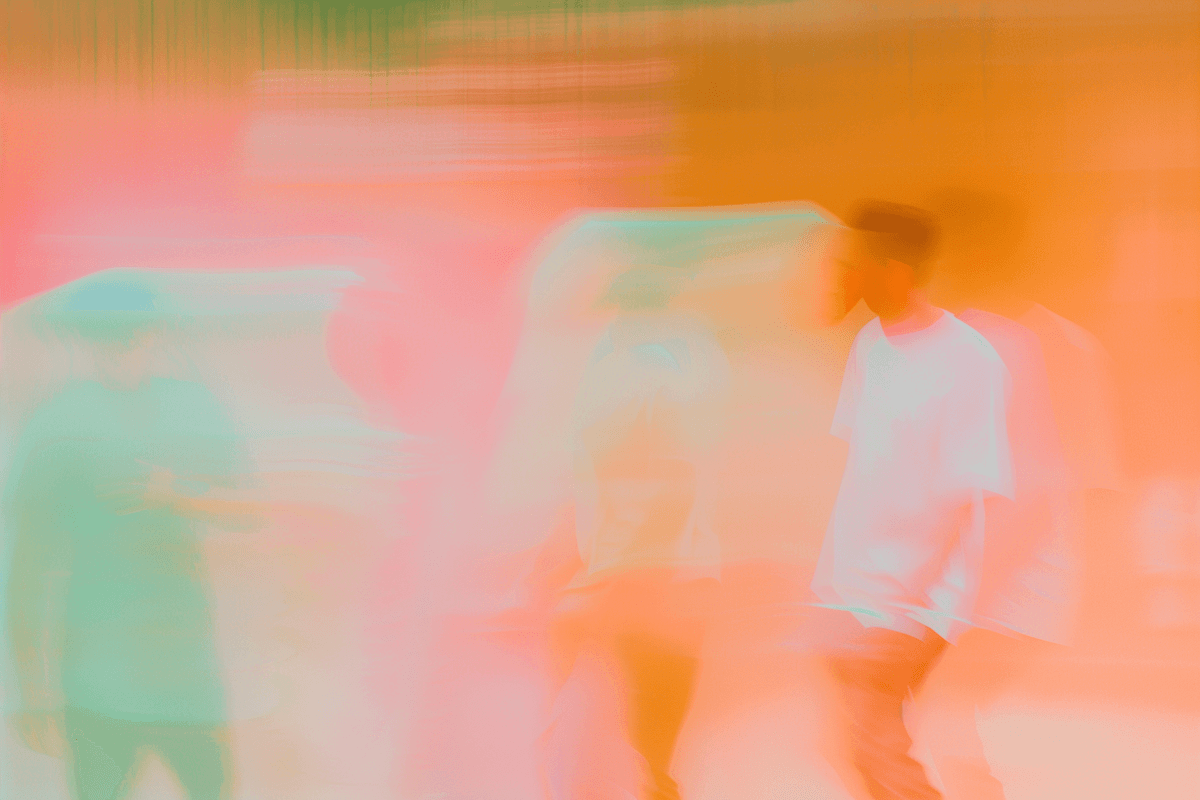 Abstract warm-toned image with orange and pink hues, blurred motion of a performer.