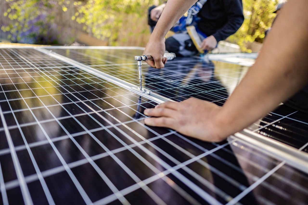 Engineer screwing in solar panel spacer