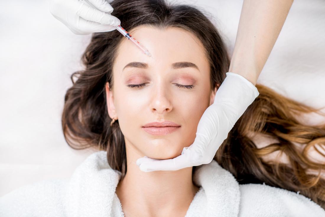 Patient receiving Botox injection in the forehead at a medical spa in Delray Beach, Florida. Aesthetic treatment for wrinkle reduction and smooth skin.