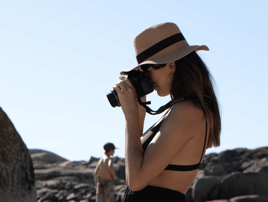 silhouette photography of man holding camera