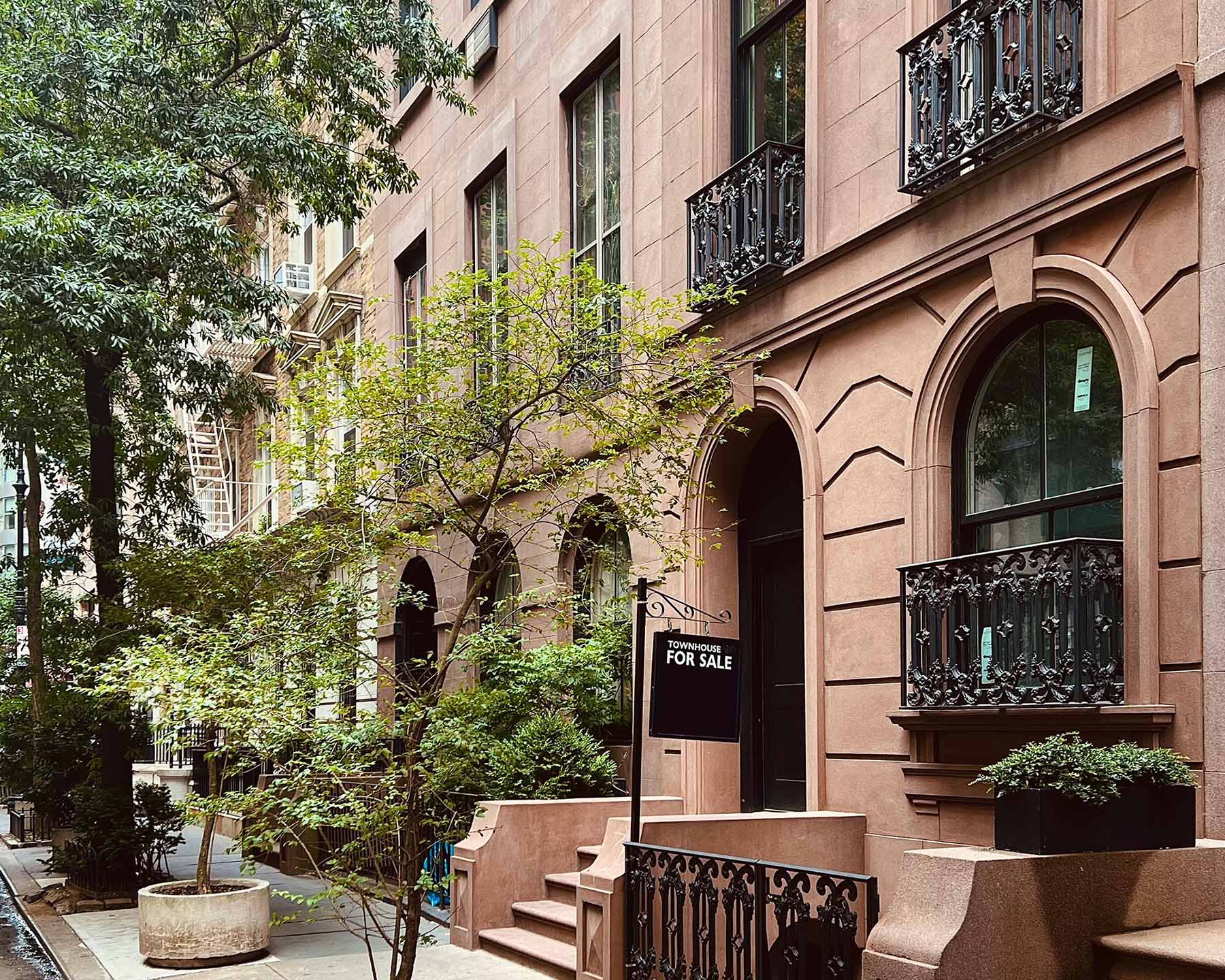 A brown stone townhouse for sale by a private real estate group in New York City