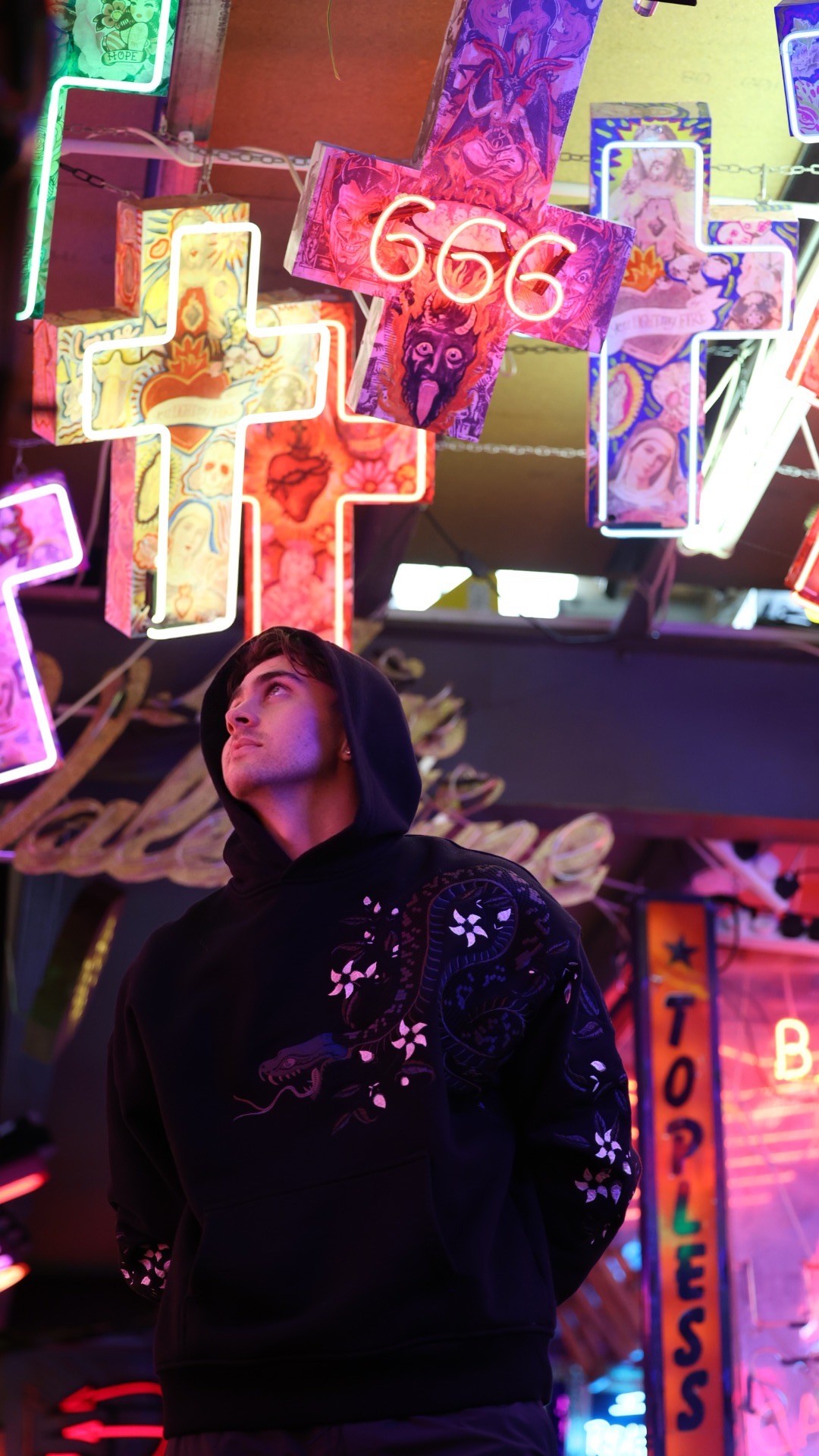 CAULEY beneath colourful neon signs