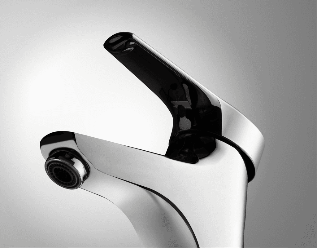 Close-up of a modern chrome bathroom faucet, shiny and reflective, showcasing its sleek design and water outlet.