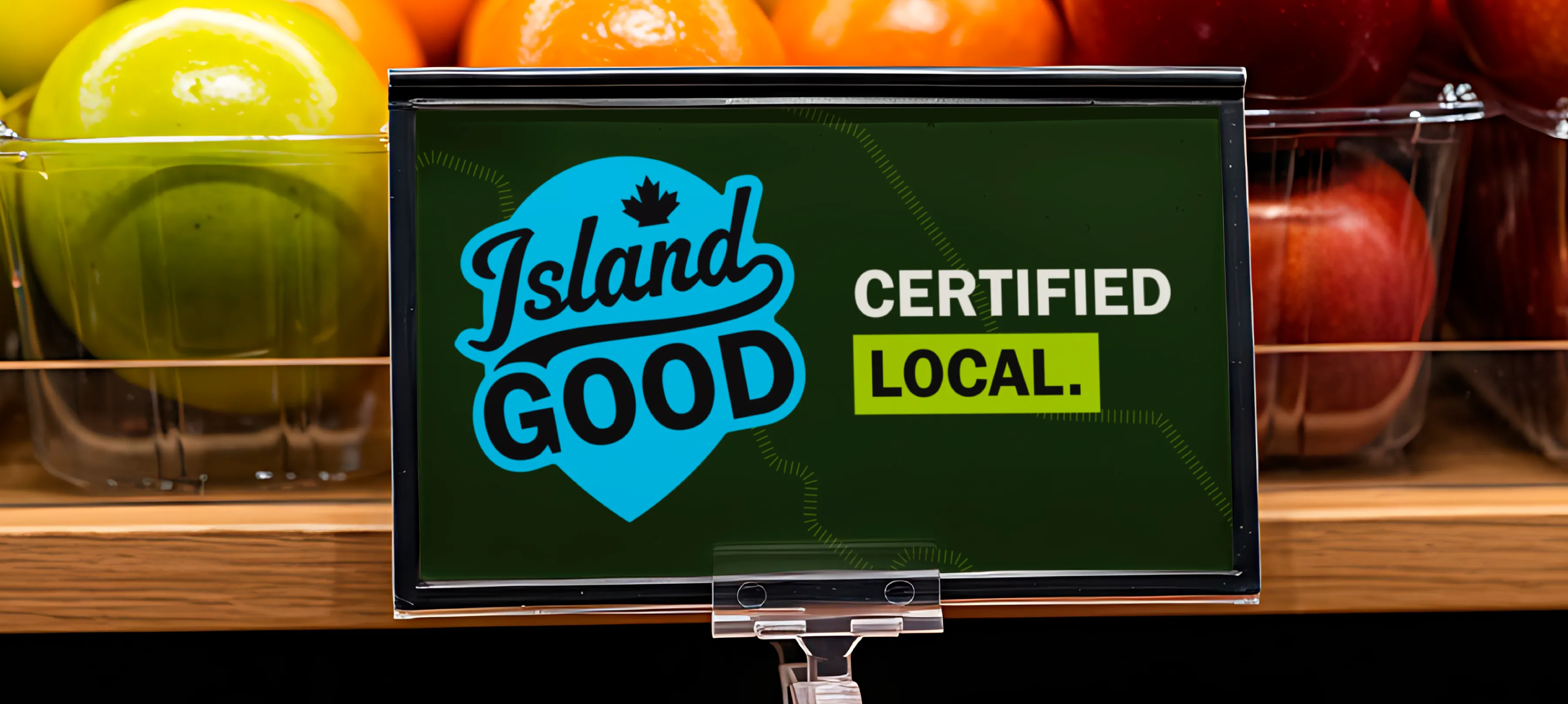 A sign that has the Island Good logo in blue with "certified local" beside it on a dark green background.